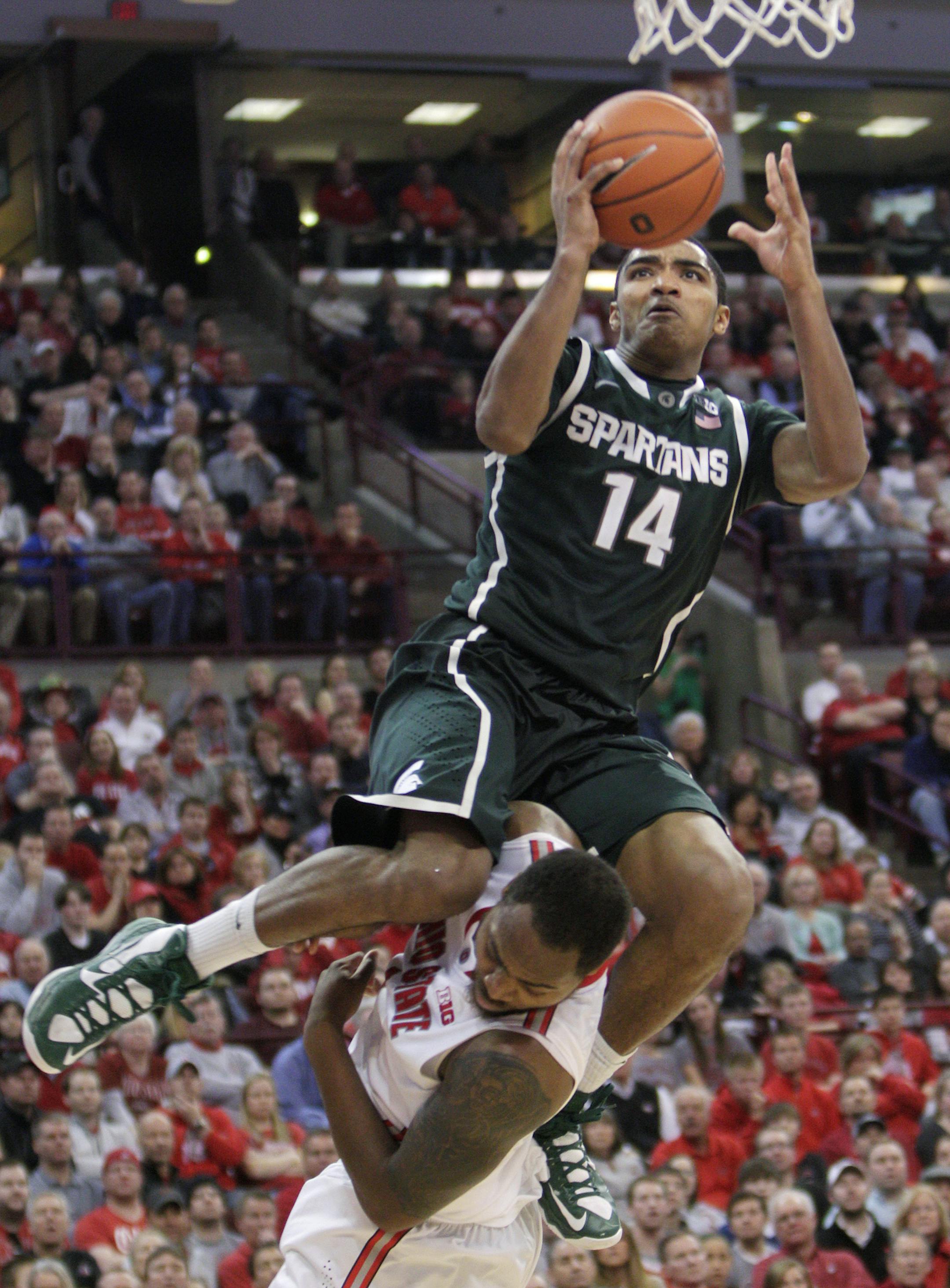 Michigan State's Gary Harris, top, shoots over Ohio State's Deshaun Thomas during the second half of an NCAA college basketball game Sunday, Feb. 24, 2013, in Columbus, Ohio. Ohio State beat Michigan State 68-60. (AP Photo/Jay LaPrete) ORG XMIT: MIN2013031315522437