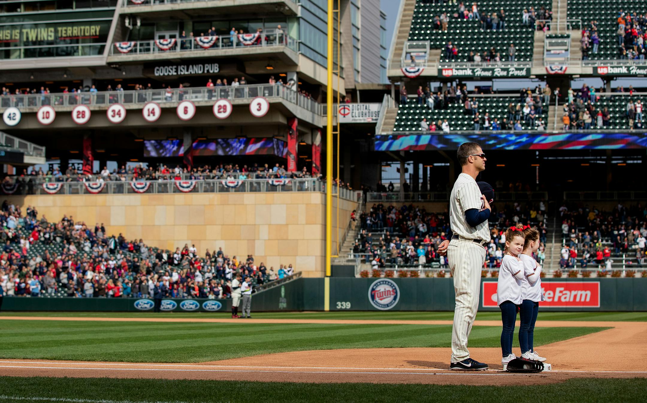 Minnesota Twins first baseman Joe Mauer and his twin daughters stood for the National Anthem before the start of the game. ] CARLOS GONZALEZ ï cgonzalez@startribune.com ñ September 30, 2018, Minneapolis, MN, Target Field, MLB, Minnesota Twins vs. Chicago White Sox