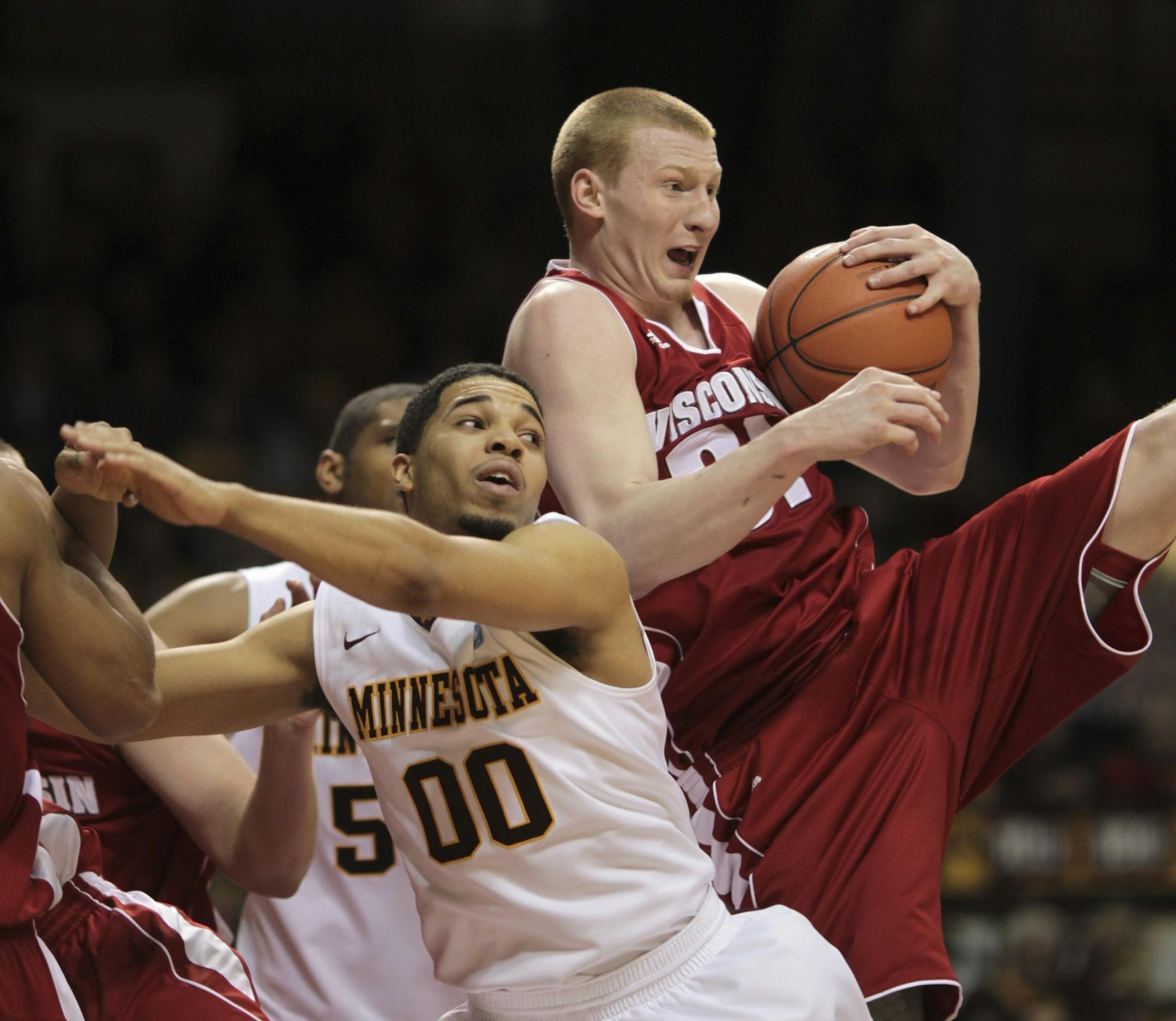 The Badgers' Mike Bruesewitz, a former star at Henry Sibley, grabbed a defensive rebound in overtime, snatching it away from Gophers guard Julian Welch.