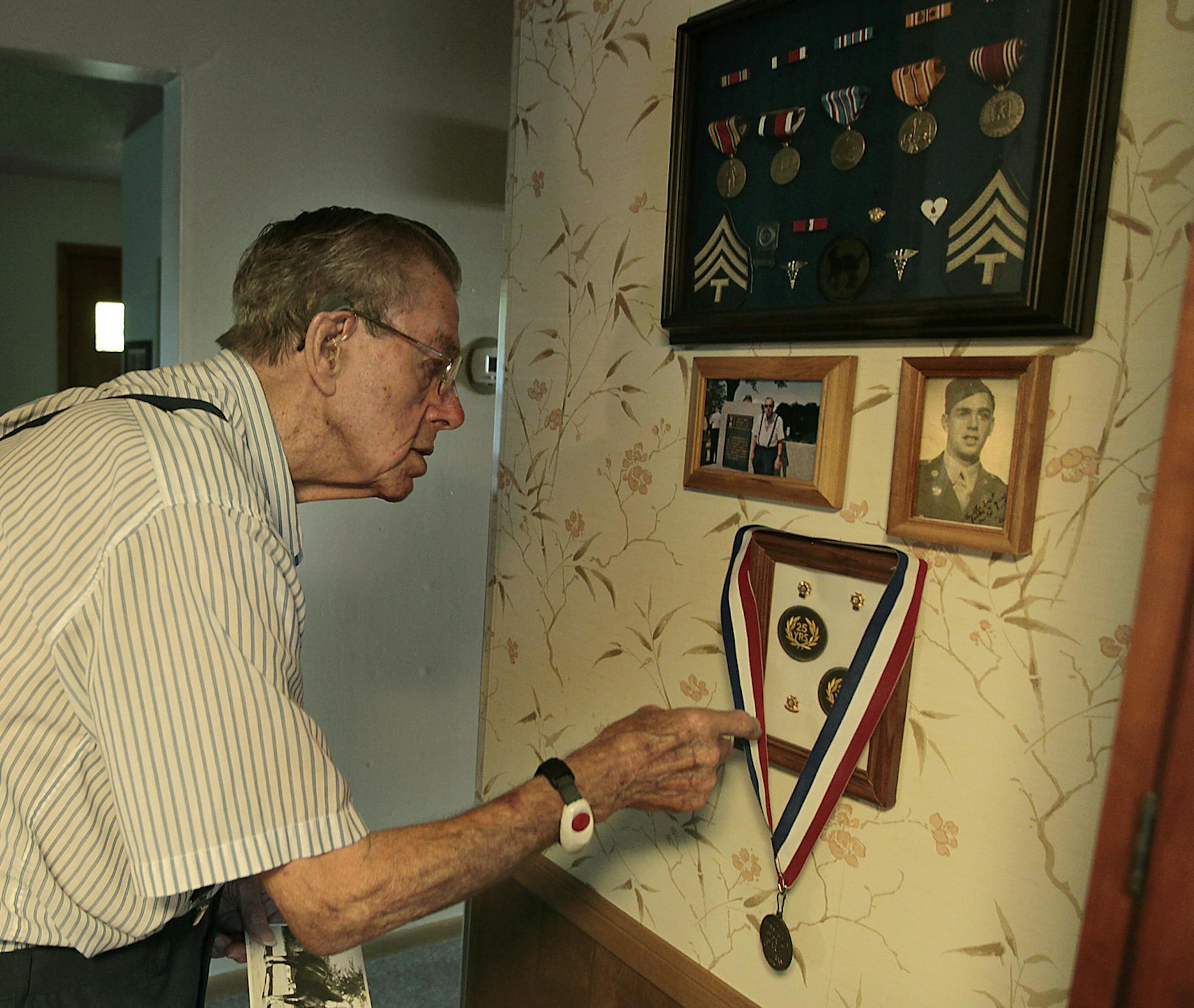 Warren Bushway, 93, proudly hung his military medals and awards next to a photo of him as a young man, Tuesday, June 24, 2014 in St. Louis Park, MN. ] (ELIZABETH FLORES/STAR TRIBUNE) ELIZABETH FLORES • eflores@startribune.com