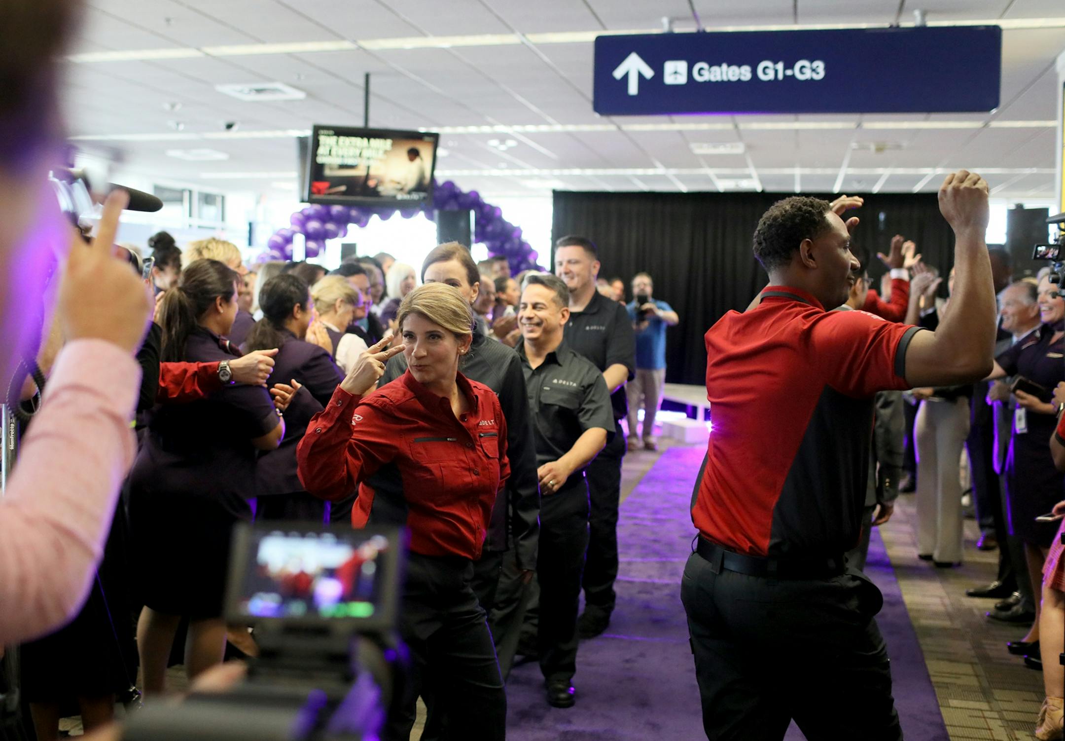Delta Air Lines launched its new line of uniforms for all its employees during a fashion show at MSP with designer Zac Posen & manufacturer Lands End showcasing the new look Tuesday, May, 29, 2018, at Terminal 1 between Gates G1-G3 at the Minneapolis-St. Paul International Airport in Bloomington, MN. Here, Delta employees in the fashion show took one last walk down the runway to the delight of other employees and onlookers.