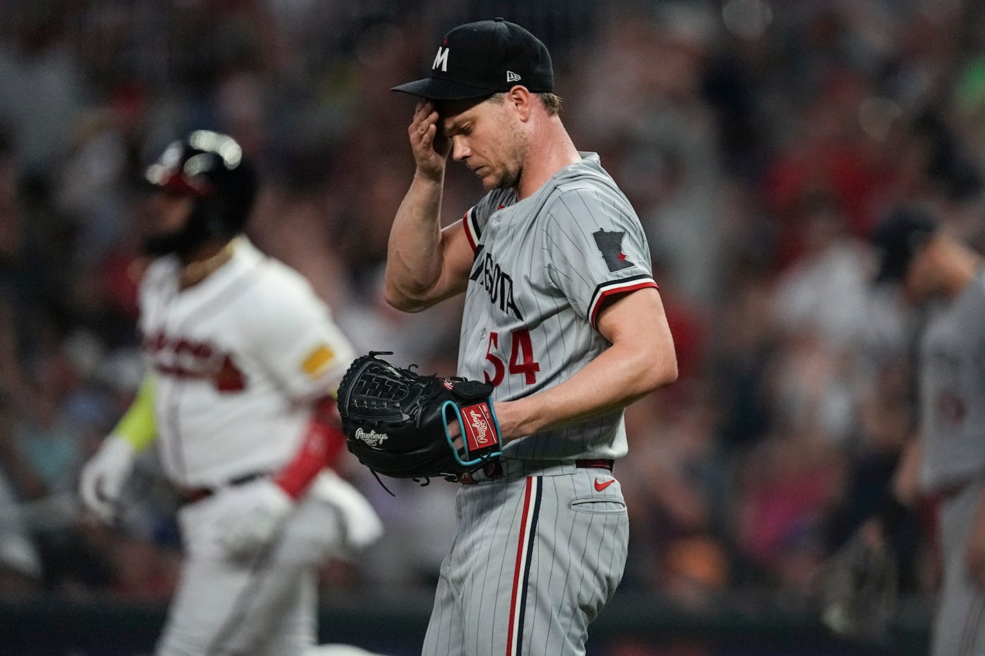 Minnesota Twins starting pitcher Sonny Gray (54) reacts as Atlanta Braves designated hitter Marcell Ozuna, back left, runs the bases after hitting a solo home run in the seventh inning of a baseball game Monday, June 26, 2023, in Atlanta. (AP Photo/John Bazemore)