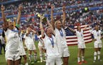 Megan Rapinoe, center, holds the trophy as she celebrates with teammates after they defeated the Netherlands 2-0 in the Women's World Cup final.