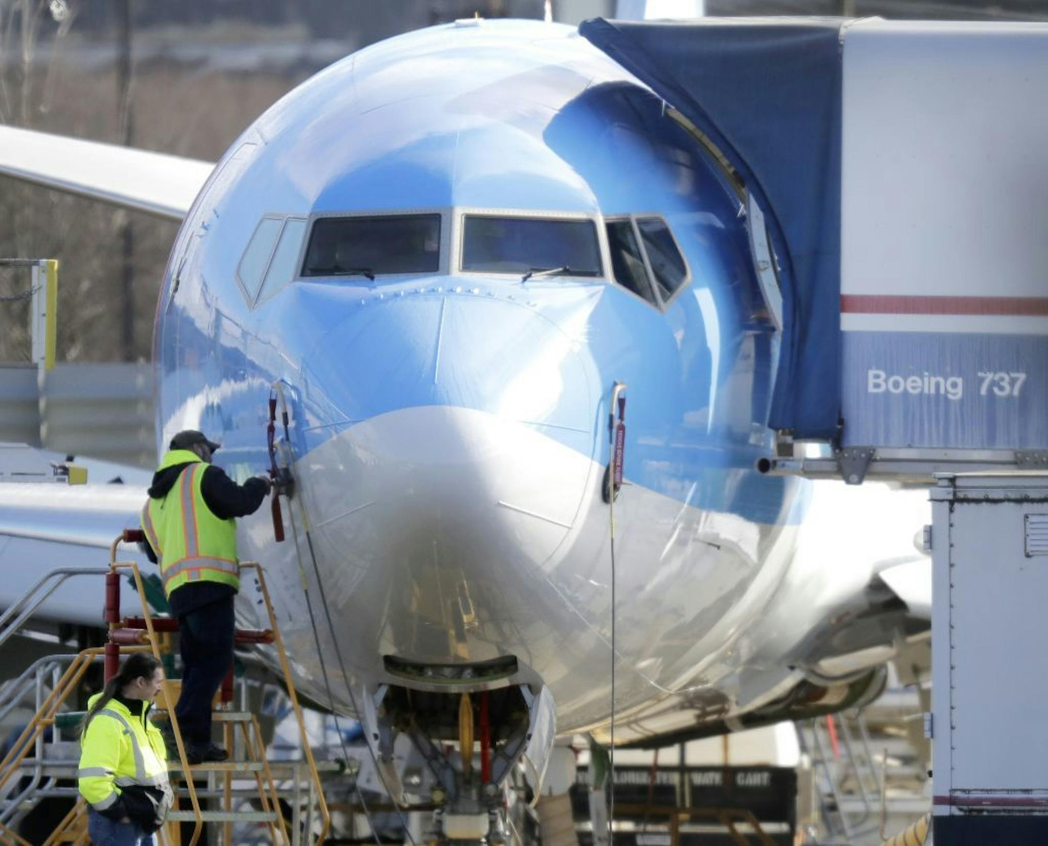 A worker stands on a platform near a Boeing 737 MAX 8 airplane being built for TUI Group at Boeing Co.'s Renton Assembly Plant Wednesday, March 13, 2019, in Renton, Wash. President Donald Trump says the U.S. is issuing an emergency order grounding all Boeing 737 Max 8 and Max 9 aircraft in the wake of a crash of an Ethiopian Airliner.