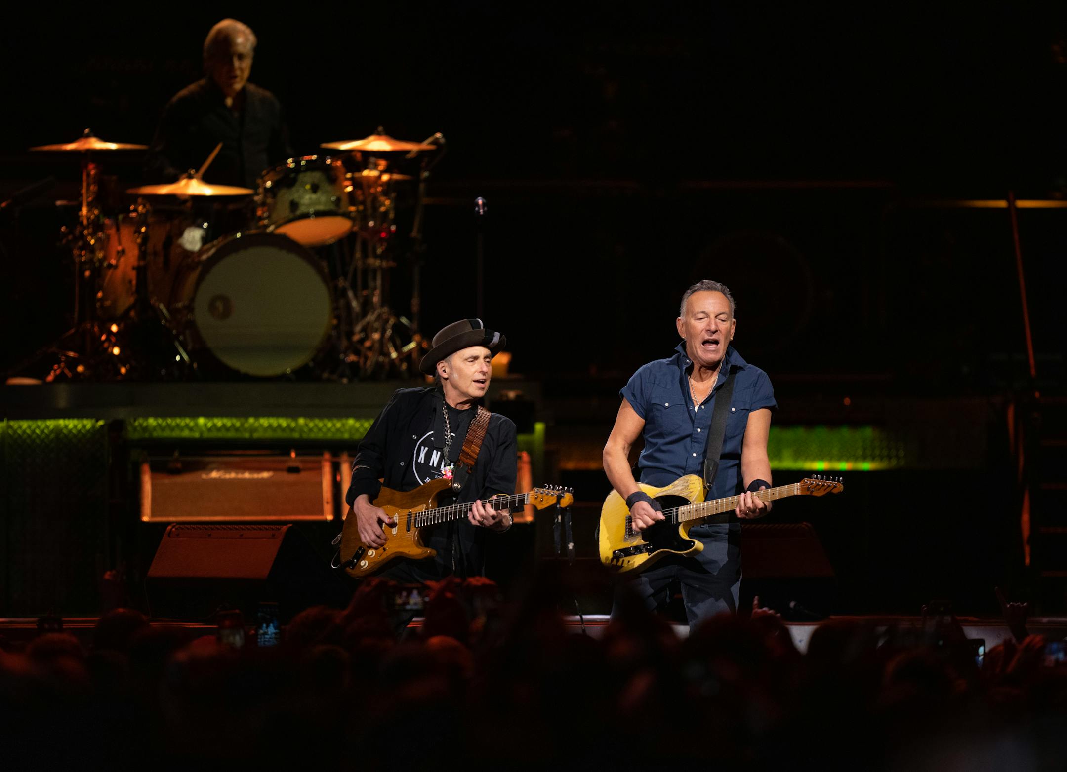 Bruce Springsteen with guitarist Nils Lofgren and drummer Max Weinberg early in their set .