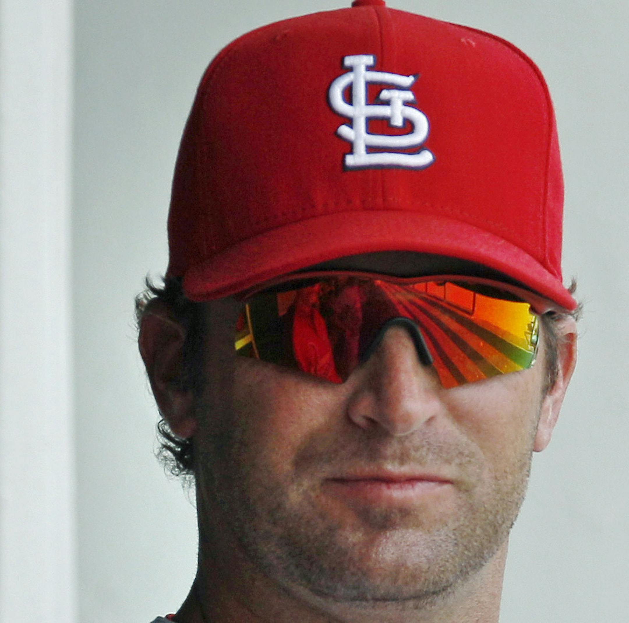 St. Louis Cardinals manager Mike Matheny watches from the dugout before facing the Minnesota Twins in a spring training baseball game in Fort Myers, Fla., Friday, March 9, 2012. (AP Photo/Charles Krupa)