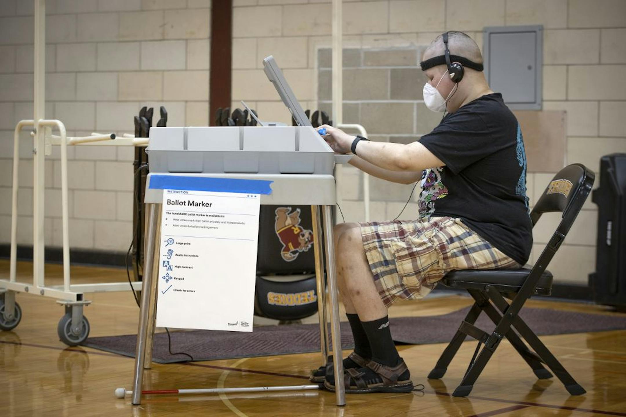 Jason White, who is visually impaired, used the AutoMARK voting machine to cast his vote at the Roosevelt High School polling location, Tuesday, August 11, 2020 in Minneapolis, MN.