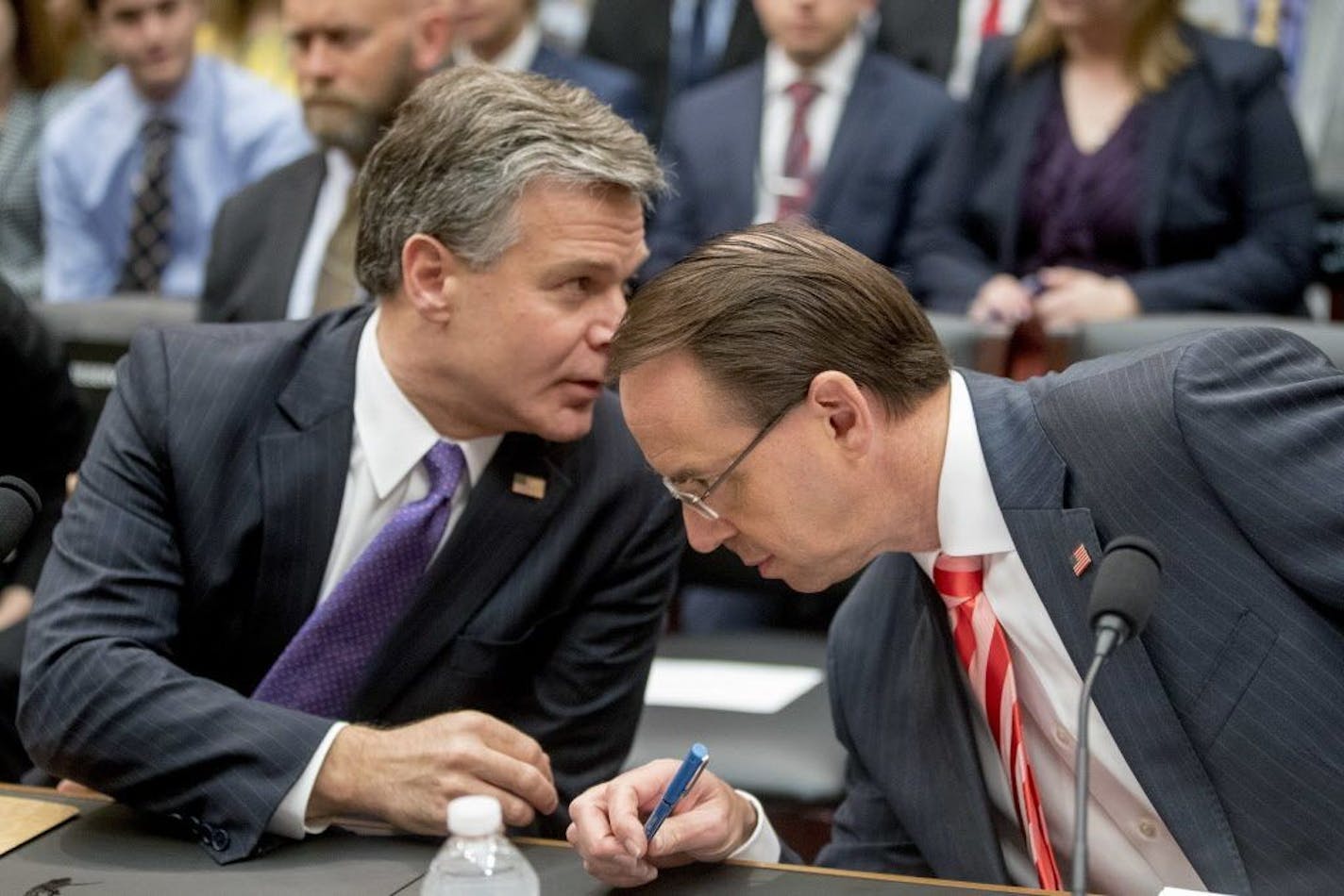 Deputy Attorney General Rod Rosenstein, right, and FBI Director Christopher Wray, left, speak together as they arrive at a House Judiciary Committee hearing on Capitol Hill in Washington, Thursday, June 28, 2018, on Justice Department and FBI actions around the 2016 presidential election.