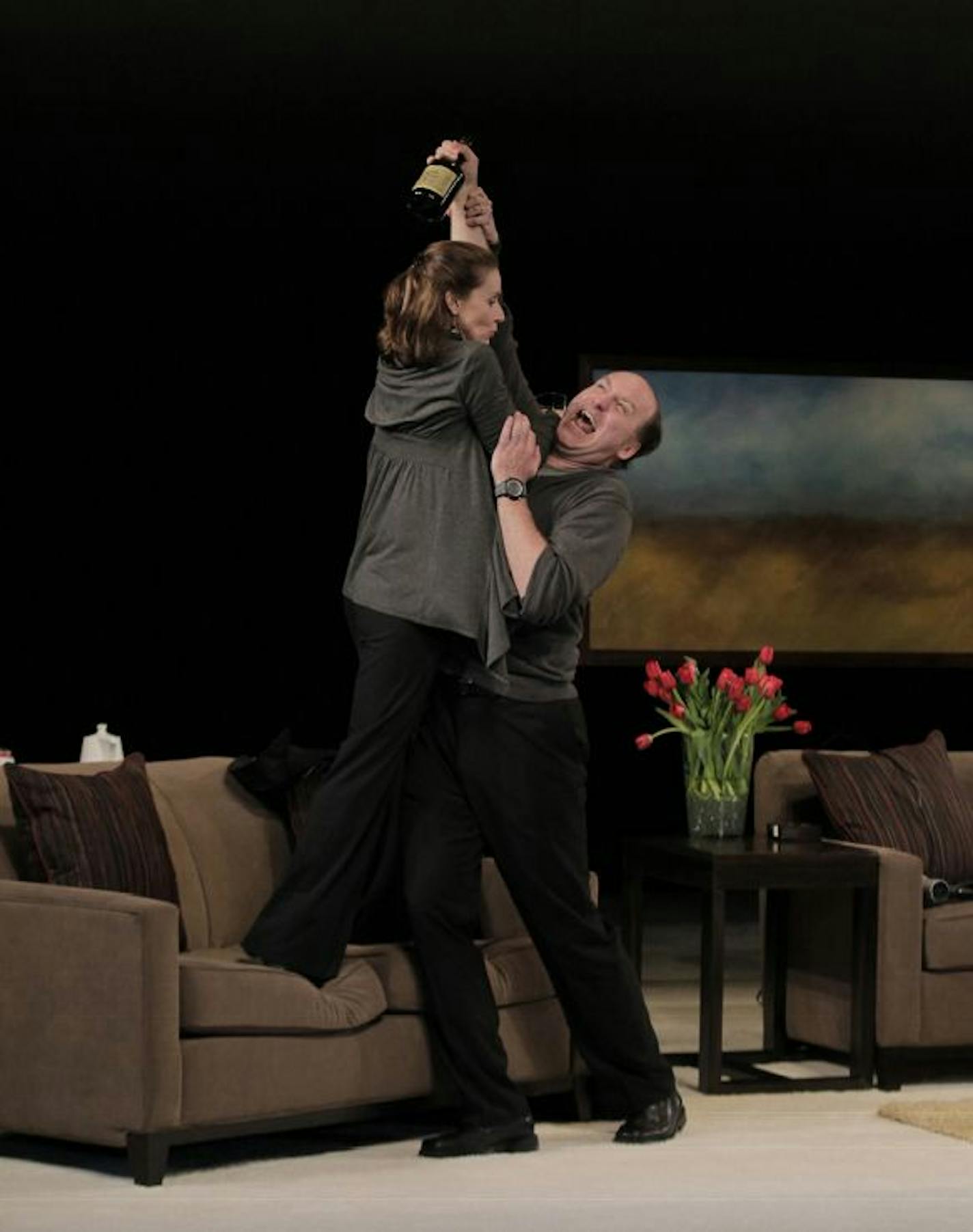 Jennifer Blagen (Veronica Novak) and Chris Carlson (Bill Novak) in the Guthrie Theater production of GOD OF CARNAGE by Yasmina Reza, translated by Christopher Hampton. Directed by John Miller-Stephany, set design by Todd Rosenthal, costume design by Mathew J. LeFebvre, lighting design by Marcus Dilliard. May 28 - August 7, 2011. Photo by Paul Kolnik