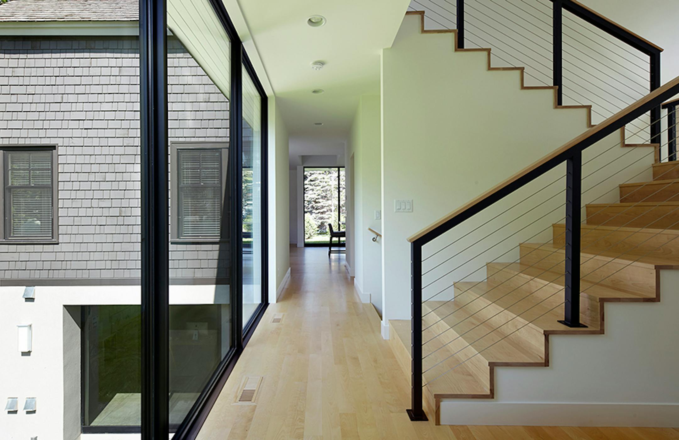 Cottagewood Residence. Lake home has shingle-style elements combined with a modern floor plan, by Peterssen/KellerArchitecture.
