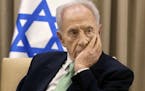 FILE - In this Oct. 28, 2013, file photo, Israel's President Shimon Peres, listens during a meeting at the president's residence in Jerusalem. A sourc