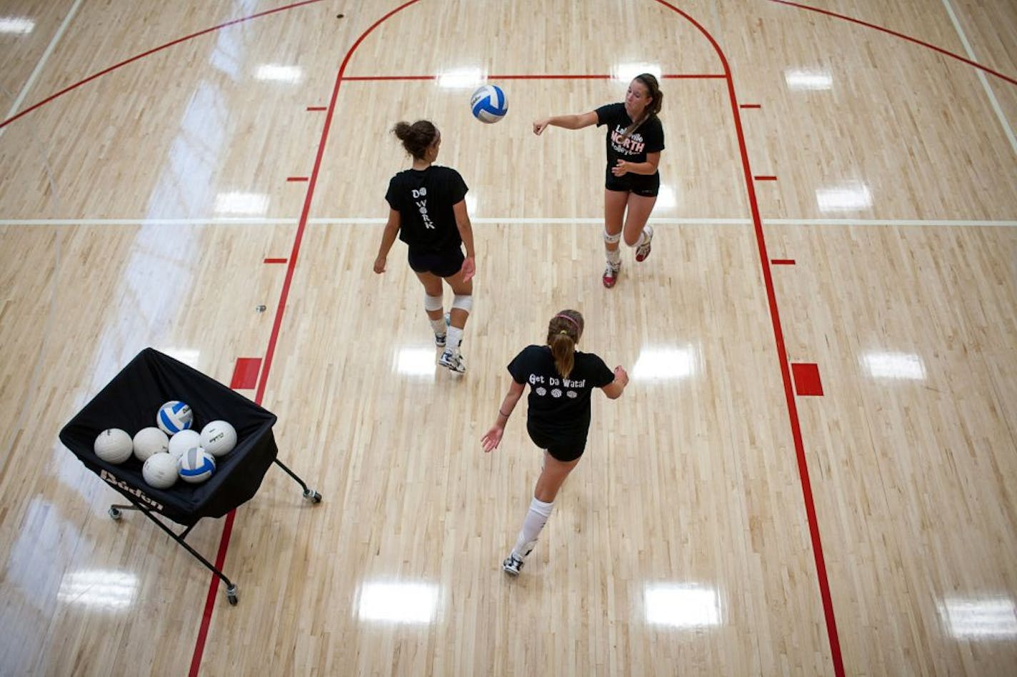 Lakeville North volleyball players practiced serving Monday.