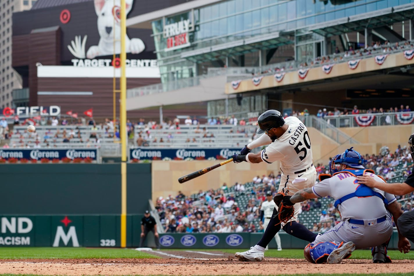 Minnesota Twins' Willi Castro (50) hits a triple in front of New York Mets catcher Francisco Alvarez during the seventh inning of a baseball game, Sunday, Sept. 10, 2023, in Minneapolis. (AP Photo/Craig Lassig)