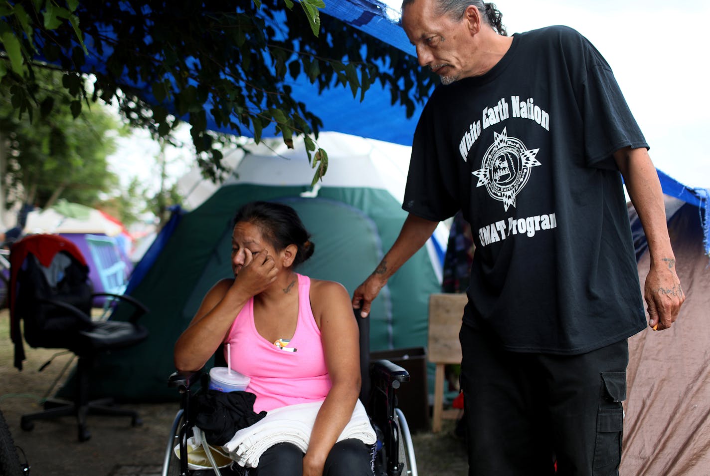 James Cross, the founder of the street outreach group Natives Against Heroin, spent nearly half of his life in prison for drug-related crimes but is working hard now to help people in his Native American community, particularly the poor and those with substance abuse problems. Here, Cross comforts Yvonne, who is in a wheelchair after being attacked a few years ago and is living in a tent, after she had become emotional while talking about her situation at the growing homeless encampment Tuesday,