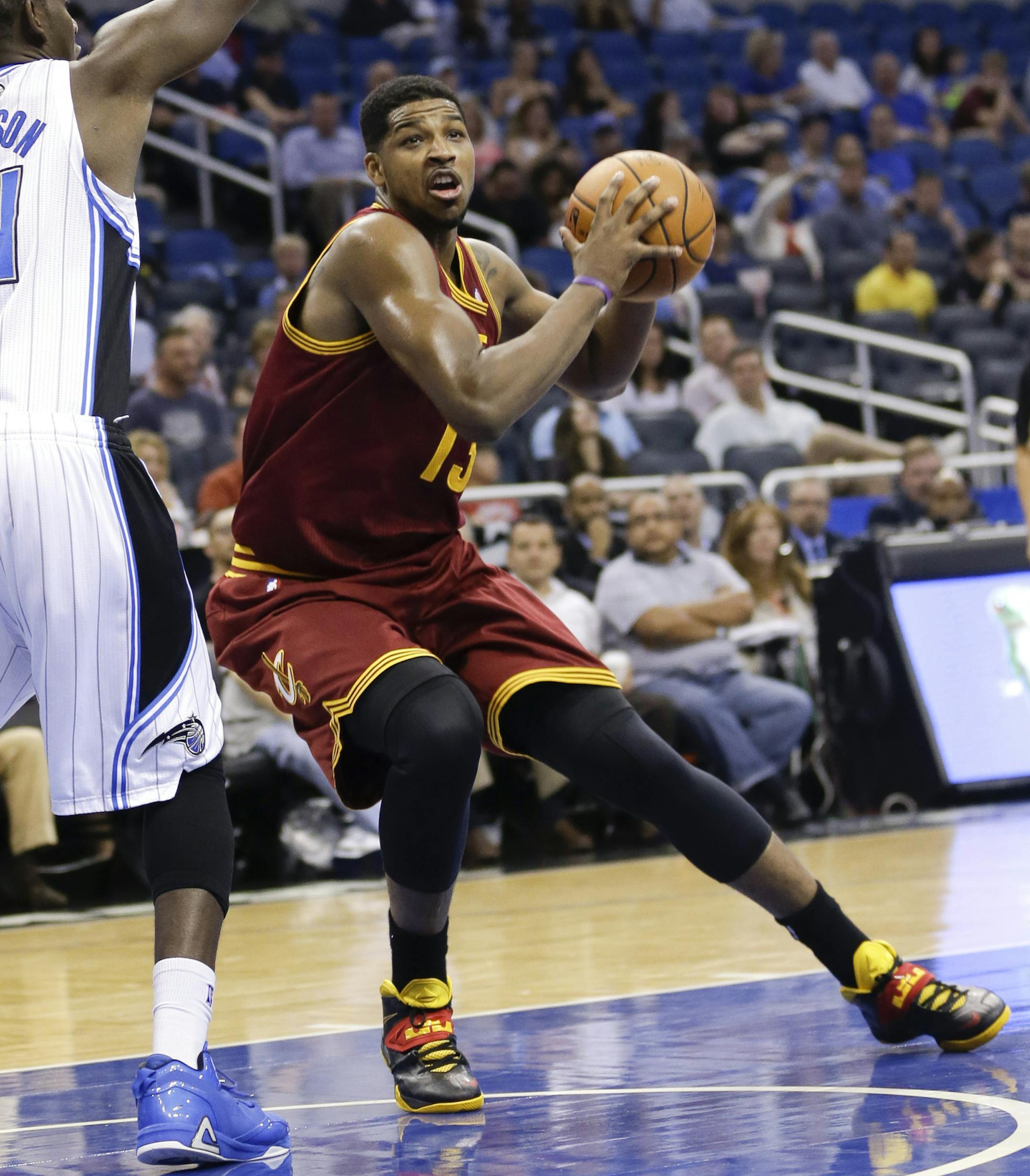 Cleveland Cavaliers' Tristan Thompson, right, moves to the basket for a shot as Orlando Magic's Andrew Nicholson (44) defends during the first half of an NBA basketball game in Orlando, Fla., Wednesday, April 2, 2014. (AP Photo/John Raoux) ORG XMIT: DOA