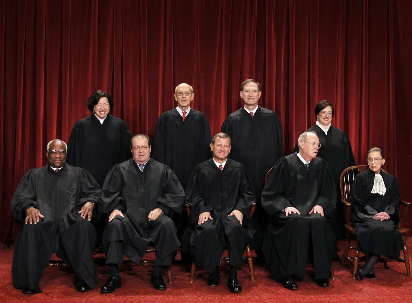 FILE - In this Oct. 8, 2010 file photo, the Supreme Court justices pose for a group photo at the Supreme Court in Washington. Seated, from left are, Justice Clarence Thomas, Antonin Scalia, Chief Justice John Roberts, Justice Anthony Kennedy, and Justice Ruth Bader Ginsburg. Standing, from left are, Justices Sonia Sotomayor, Stephen Breyer, Samuel Alito Jr., and Elena Kagan. On Saturday, Feb. 13, 2016, the U.S. Marshals Service confirmed that Scalia has died at the age of 79. (AP Photo/Pablo Mar