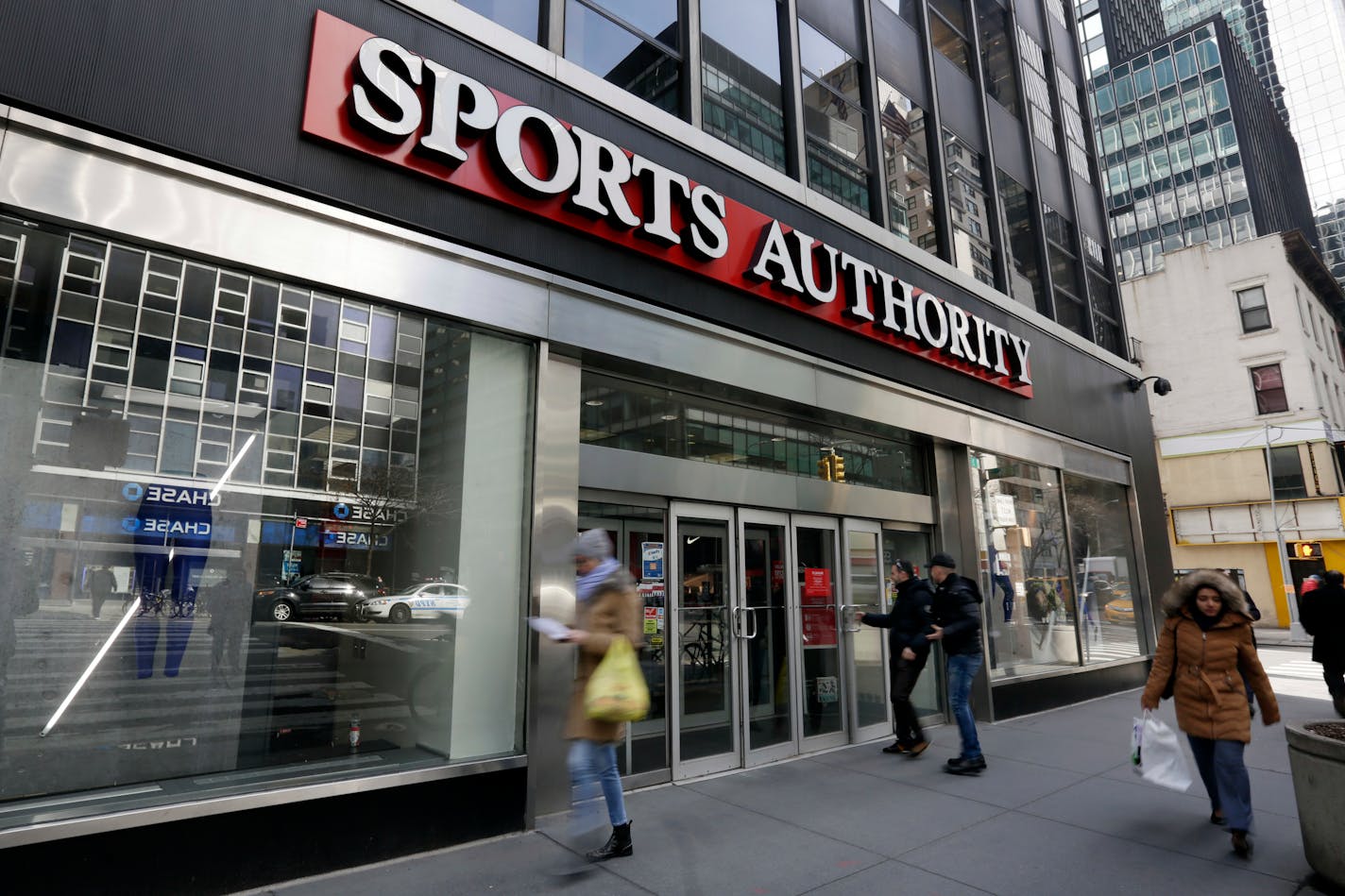 People enter a Sports Authority store, in New York, Wednesday, March 2, 2016. Sports Authority is filing for Chapter 11 bankruptcy protection. The Englewood, Colo., company has 463 stores in 41 states and Puerto Rico. (AP Photo/Richard Drew)