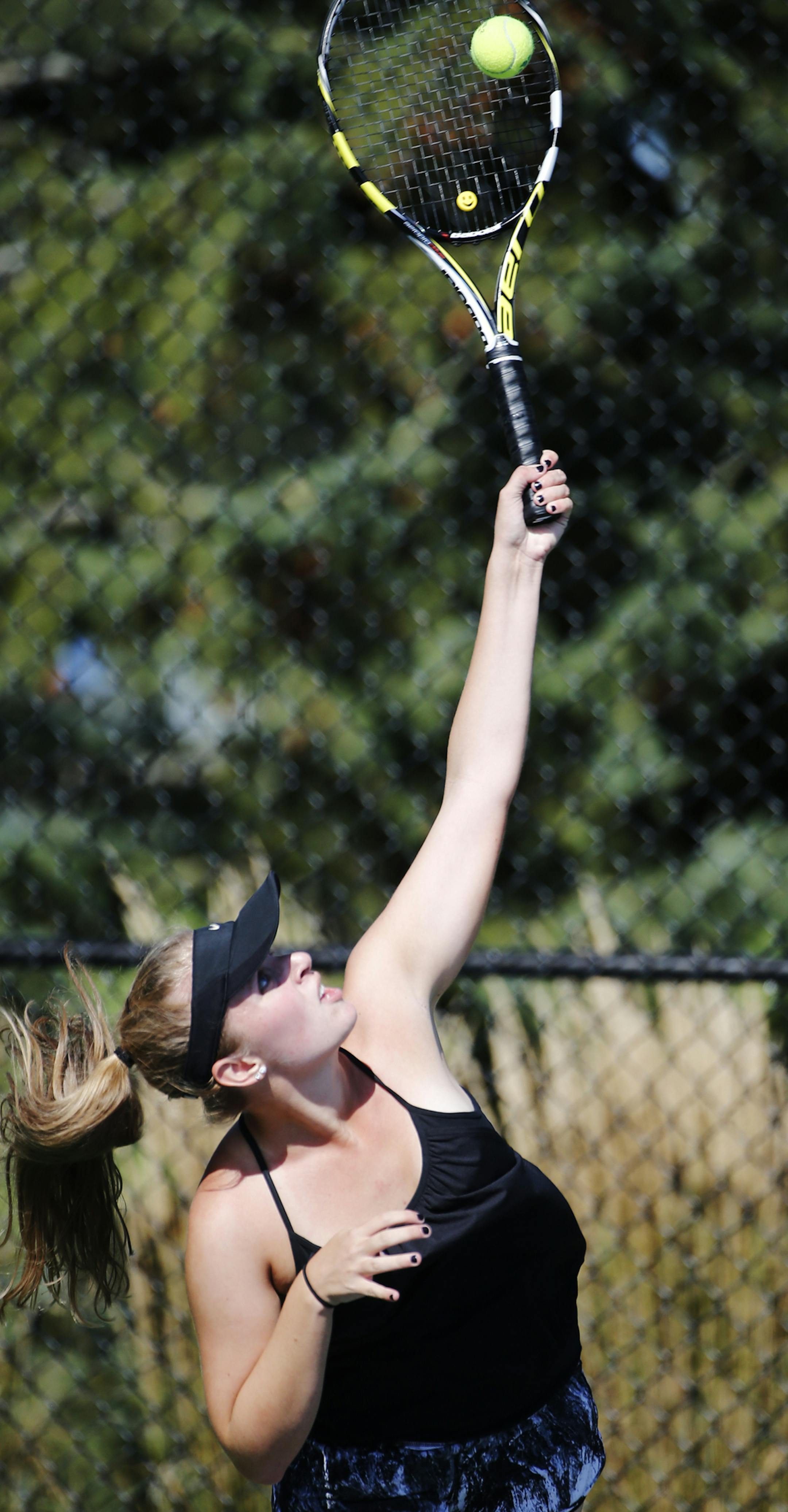 During practice for the girls' tennis team at Eagan H.S., Kjorte Harra served up. ]Richard Tsong-Taatarii/rtsong-taatarii@startribune.com