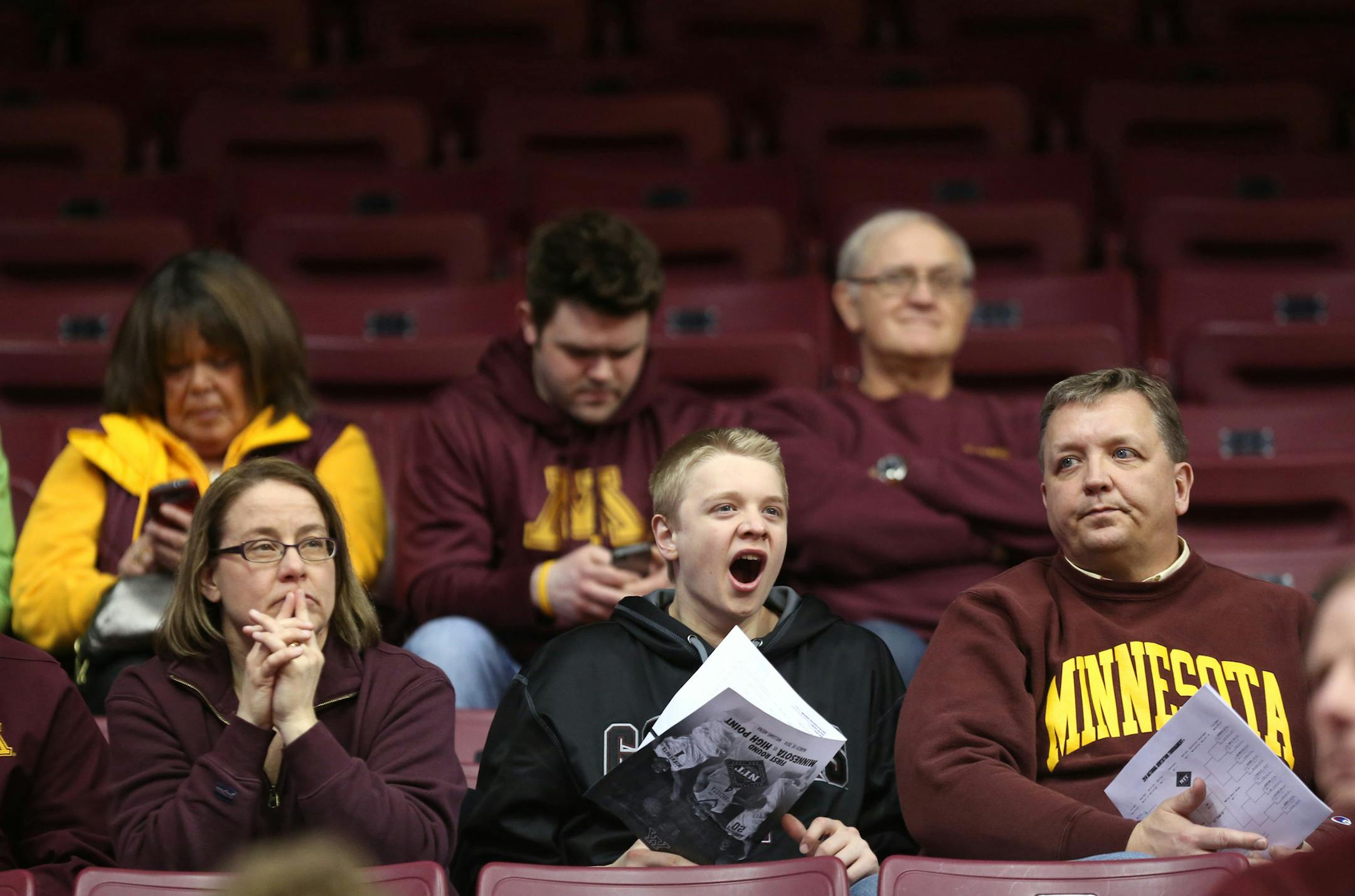 Gopher fan Will Farm, 15, of Rochester yawned a bit during a timeout on the floor in the first half against High Point. ] (KYNDELL HARKNESS/STAR TRIBUNE) kyndell.harkness@startribune.com First round of the National Invitational Tournament at Williams Arena in Minneapolis Min, Tuesday March 18, 2014.