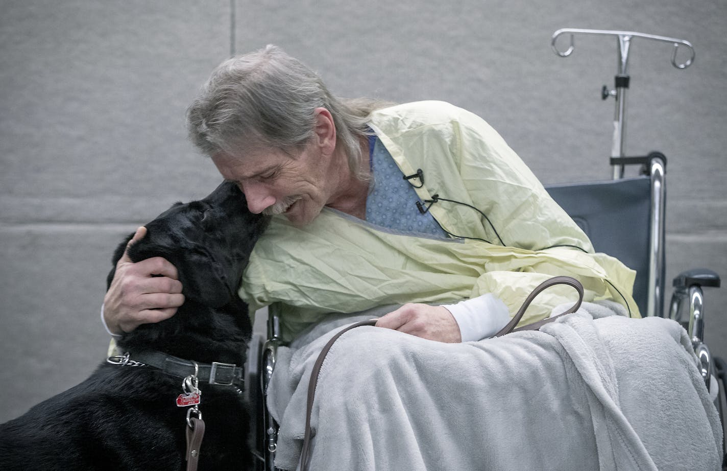 Homeless man Jay Mitchell, hospitalized in the burn unit at HCMC the past week after suffering from frostbite, became emotional after he was reunited wit his dog, "Hero" at HCMC, Tuesday, February 5, 2019 in Minneapolis, MN. "He's all I have," said Mitchell. ] ELIZABETH FLORES &#x2022; liz.flores@startribune.com