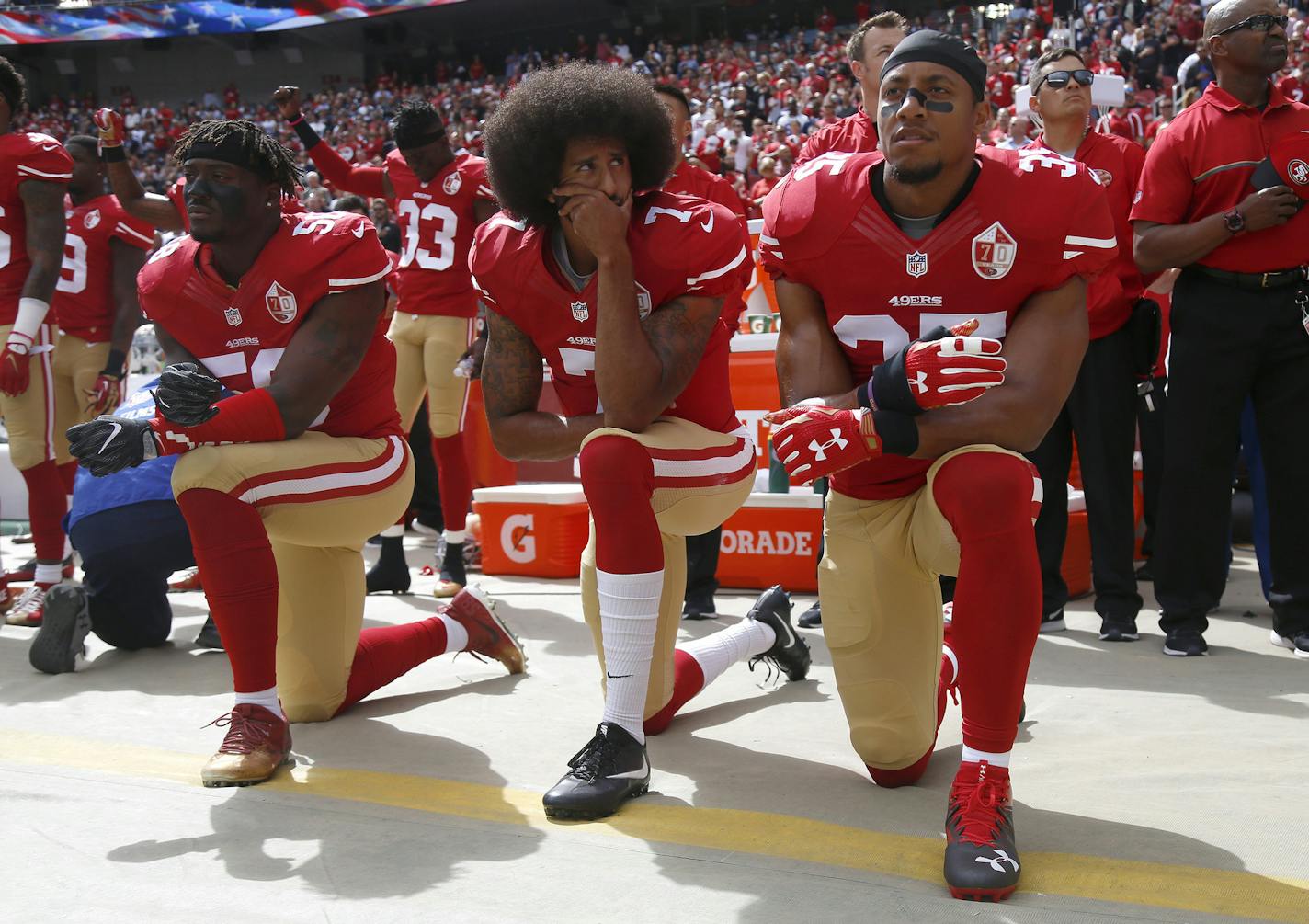 From left, San Francisco 49ers Eli Harold (58), quarterback Colin Kaepernick (7) and Eric Reid (35) kneel during the national anthem before their NFL game against the Dallas Cowboys on Sunday, Oct. 2, 2016 at Levi's Stadium in Santa Clara