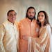 This photograph released by the Reliance group shows from L to R, billionaire industrialist Mukesh Ambani, son Anant and wife Nita, posing for a photo