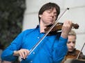 FILE - In this Sept. 30, 2014, file photo, violinist Joshua Bell performs with young musicians at Union Station in Washington. Bell will be featured w