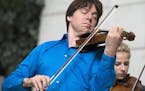 FILE - In this Sept. 30, 2014, file photo, violinist Joshua Bell performs with young musicians at Union Station in Washington. Bell will be featured w
