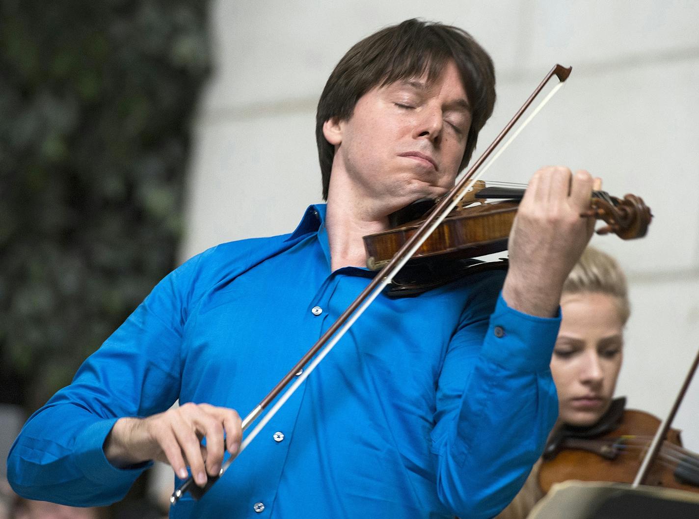 FILE - In this Sept. 30, 2014, file photo, violinist Joshua Bell performs with young musicians at Union Station in Washington. Bell will be featured when the Boston Symphony Orchestra opens its outdoor season at Tanglewood on Friday, July 8, in Lenox, Mass. (AP Photo/Molly Riley, File) ORG XMIT: BX203