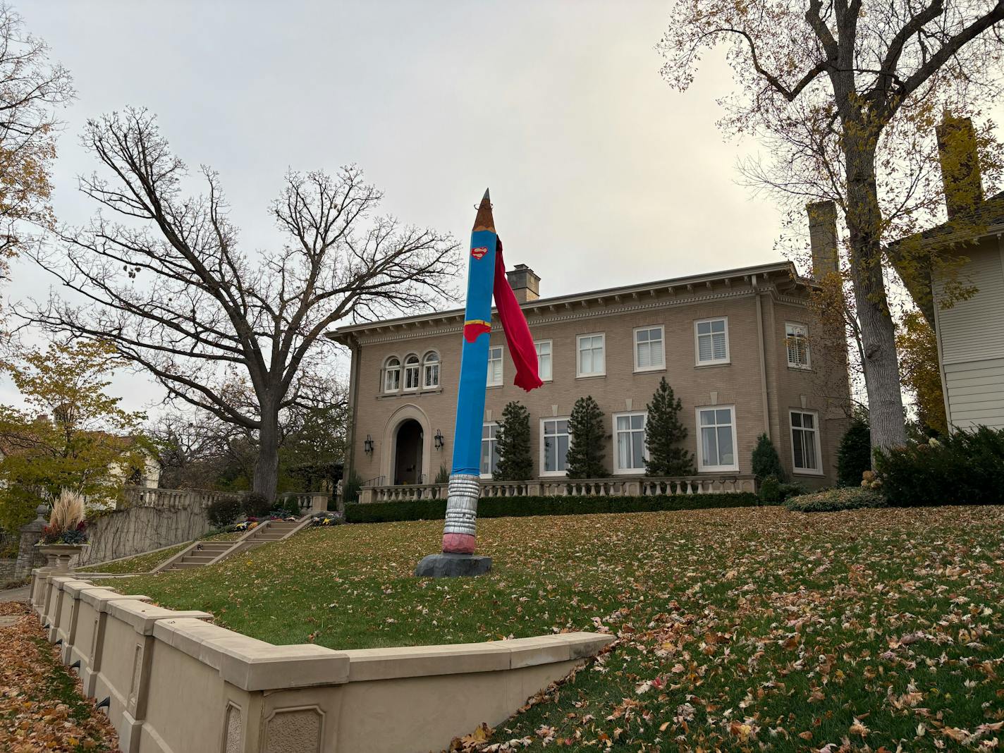 A pencil sculpture dressed up as Superman.