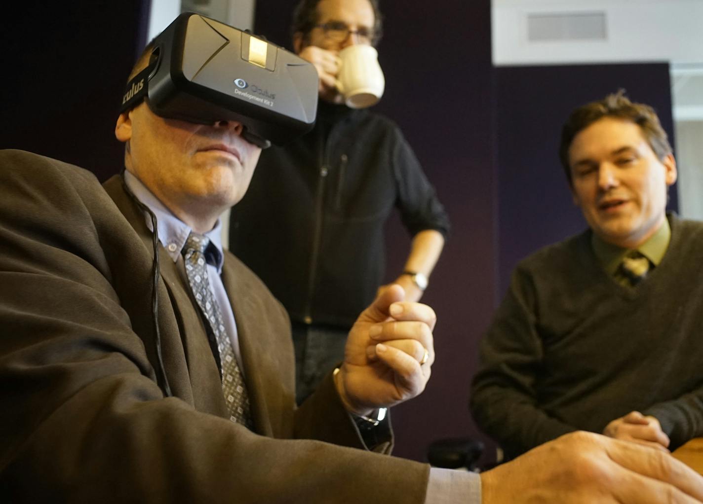 Developer Douglas Boser checks out the Remax Results Andover office 3D visualization. In the background is director of design R. Bruce Cornwall.