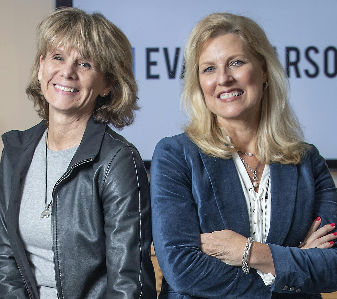 Susan Evans, left, and Teresa McFarland get a little stumped trying to describe all the work that goes on among their colleagues.