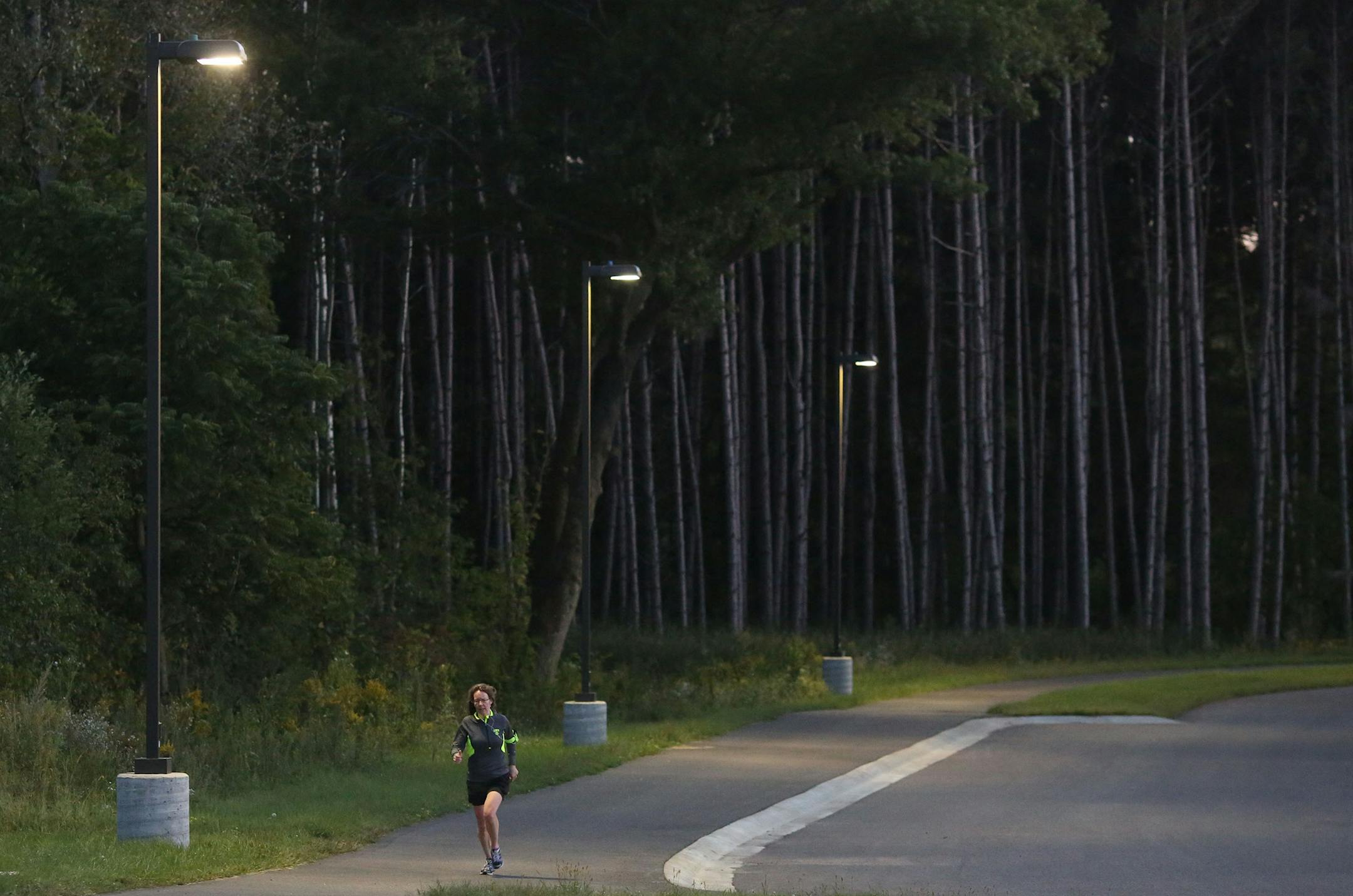 Shelly Koithan, of Oakdale, finished up her run under the parking lot lights. The park has 5 miles of trails with solar luminaries for moonlight hiking. The park with stay open until 9:30pm. ] (KYNDELL HARKNESS/STAR TRIBUNE) kyndell.harkness@startribune.com At the Lake Elmo Park Preserve in Lake Elmo Min., Thursday, September 12, 2014.