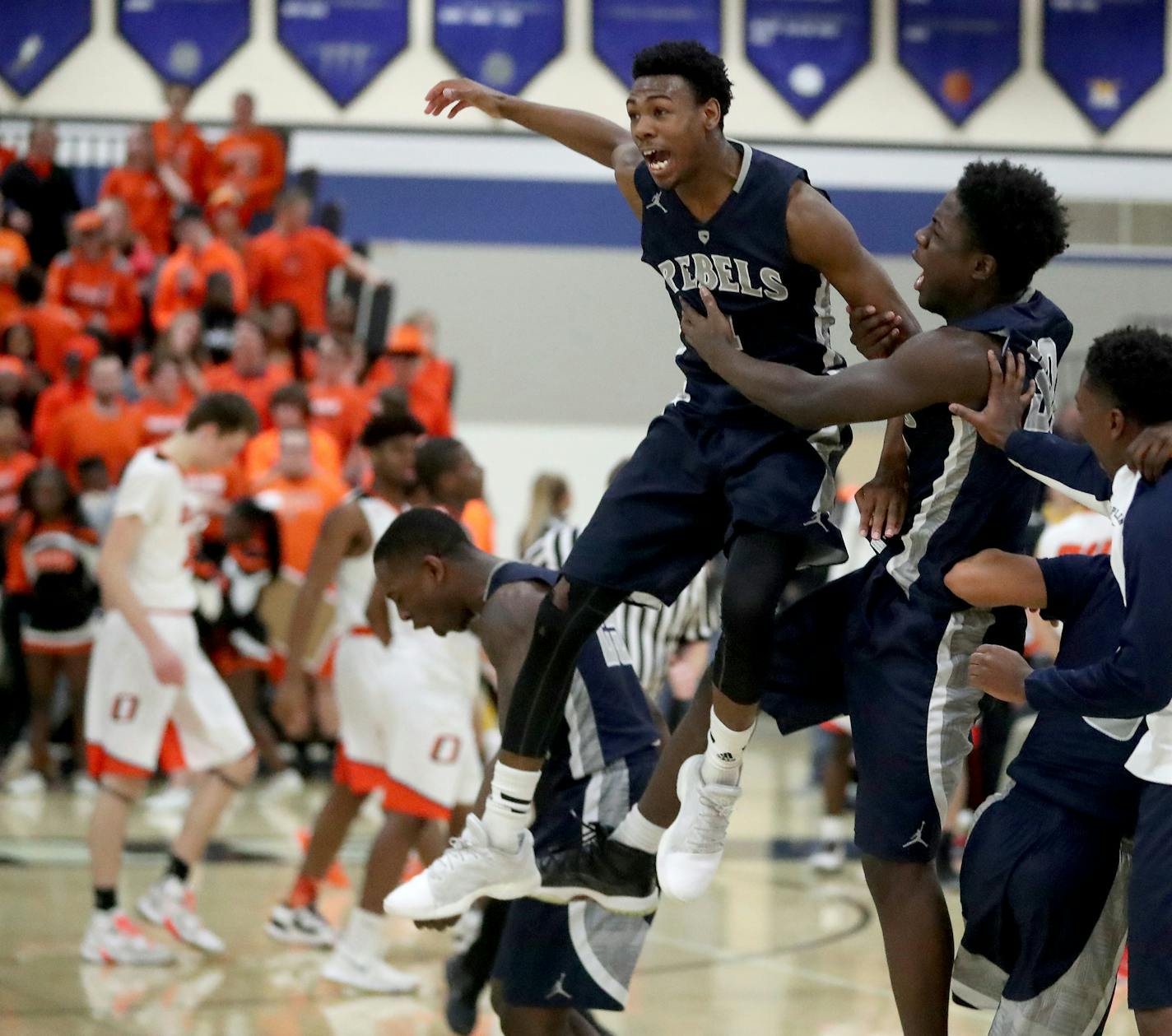 Champlin Park's Marcus Hill, center, leaps into the air after his team defeated Osseao 79-74 during the Boys' basketball, Class 4A, Section 5 final Friday, March 17, 2017, at Rogers High in Rogers, MN. Chaplin Park won 79-74.] DAVID JOLES &#xef; david.joles@startribune.com Boys' basketball, Class 4A, Section 5 final Friday, March 17, 2017, at Rogers High in Rogers, MN.