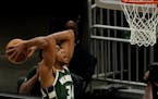 Milwaukee Bucks' Giannis Antetokounmpo goes up for a dunk during the first half of an NBA basketball game against the Sacramento Kings Sunday, Feb. 21