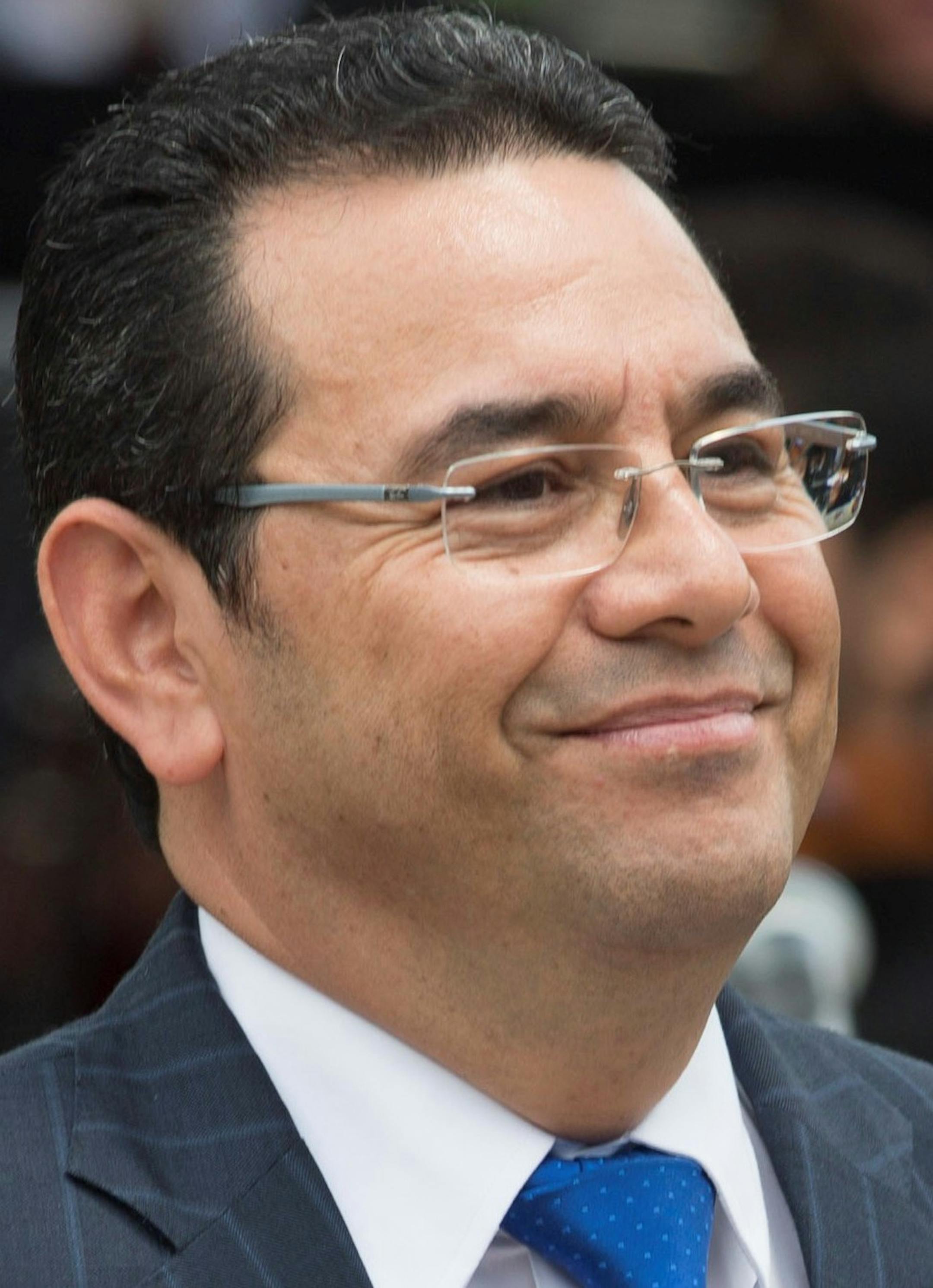 Guatemalan President Jimmy Morales leaves the podium during the inauguration of a park in Guatemala City, Tuesday, Sept. 12, 2017. Lawmakers voted against lifting the president's immunity from prosecution, hours after a congressional commission recommended the protection be withdrawn to open the way for a possible trial on campaign-finance accusations. (AP Photo/Moises Castillo) ORG XMIT: XMC110