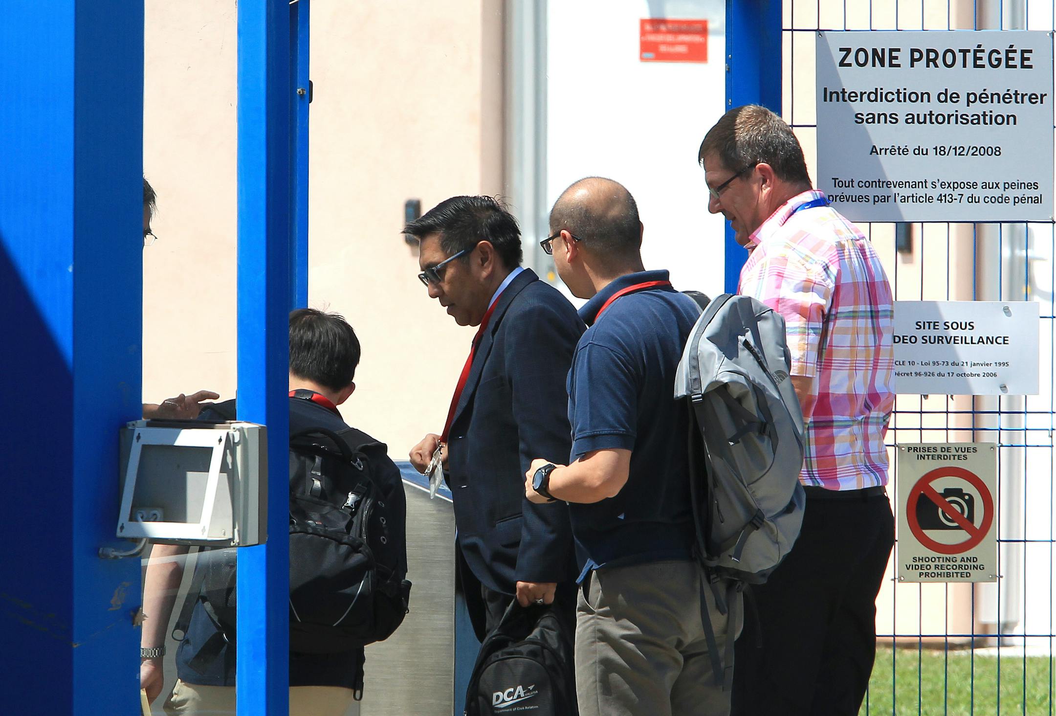 Malaysia's Department of Civil Aviation Director General Azharuddin Abdul Rahman, second left, arrives at the Direction Generale de l'Armement (DGA) facilities in Balma, near Toulouse, south-western France, Wednesday, Aug. 5, 2015 to start to examine an airplane wing fragment that many people believe could offer the first tangible clue into the fate of the missing Malaysia Airlines Flight 370. Malaysia Airlines Flight 370 vanished in March 2014 while flying from Kuala Lumpur to Beijing with 239