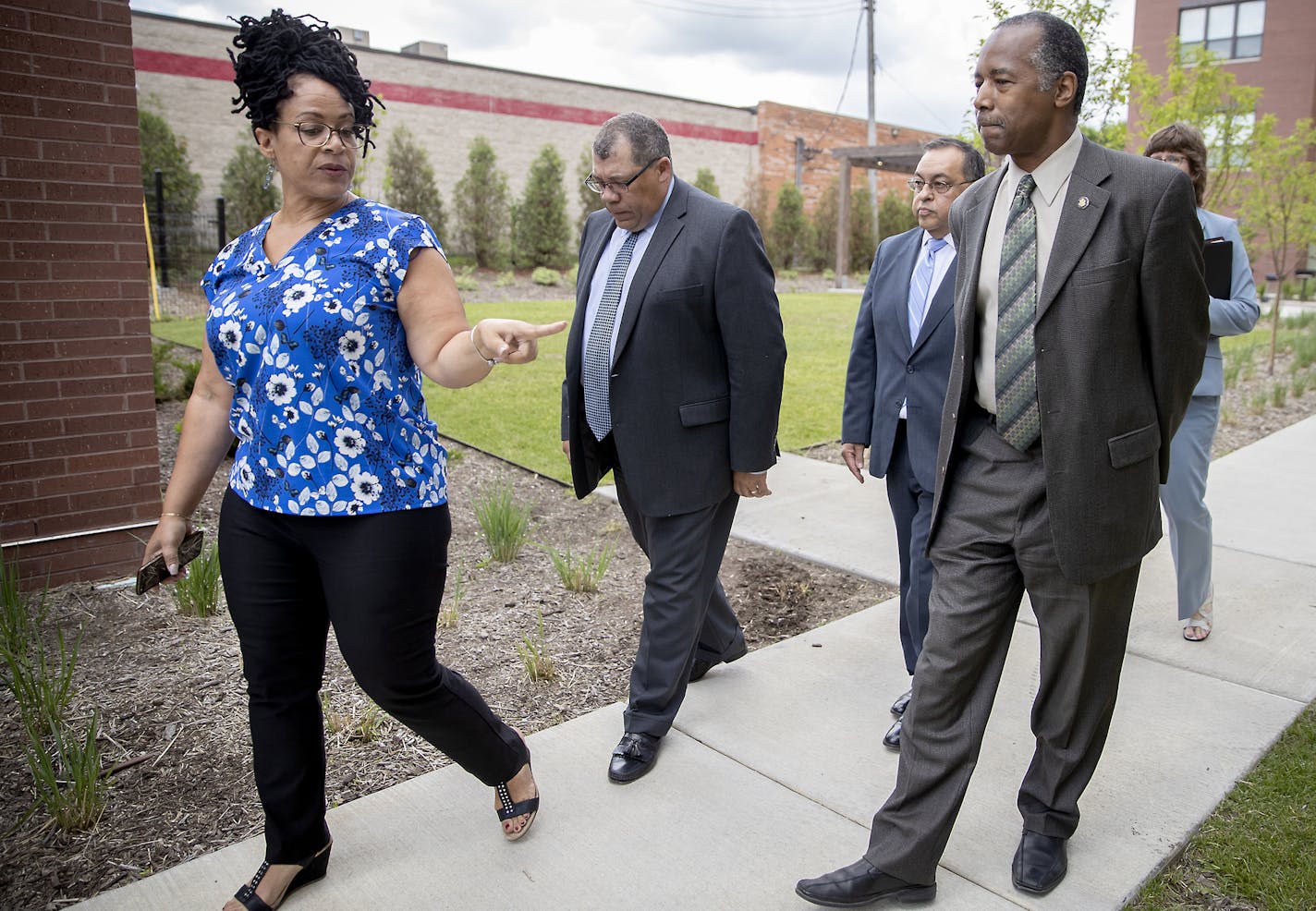 Project for Pride Property Manager Candice Rosalez, left, and CEO Paul Williams, center, gave Housing and Urban Development Secretary Ben Carson a tour of the EcoVillage Apartments, Tuesday, June 18, 2019 in Minneapolis, MN. ] ELIZABETH FLORES &#x2022; liz.flores@startribune.com