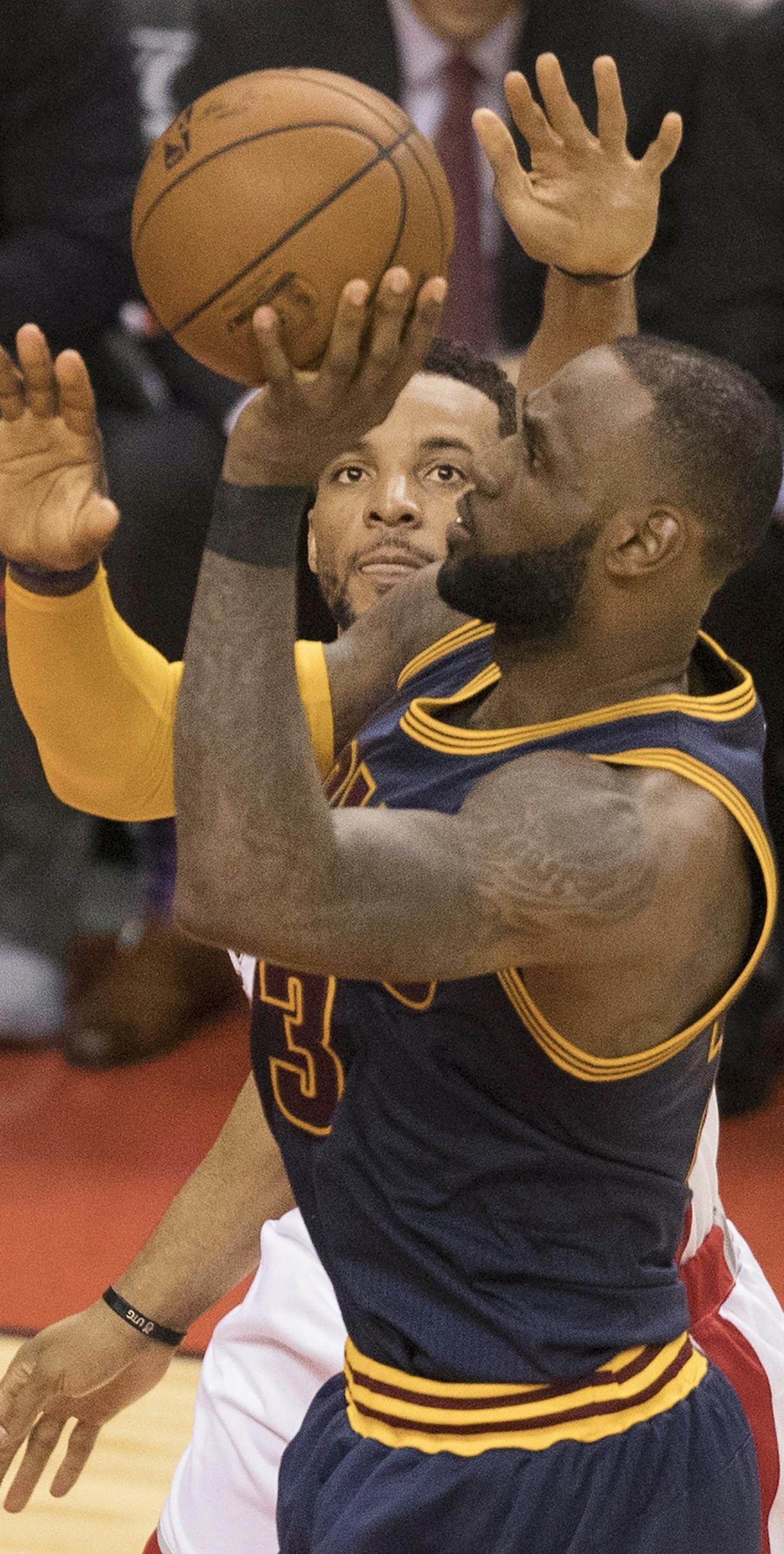 Cleveland Cavaliers' LeBron James shoots past Toronto Raptors' Norman Powell during the second half of Game 3 of an NBA basketball second-round playoff series in Toronto on Friday, May 5, 2017. (Fred Thornhill/The Canadian Press via AP)