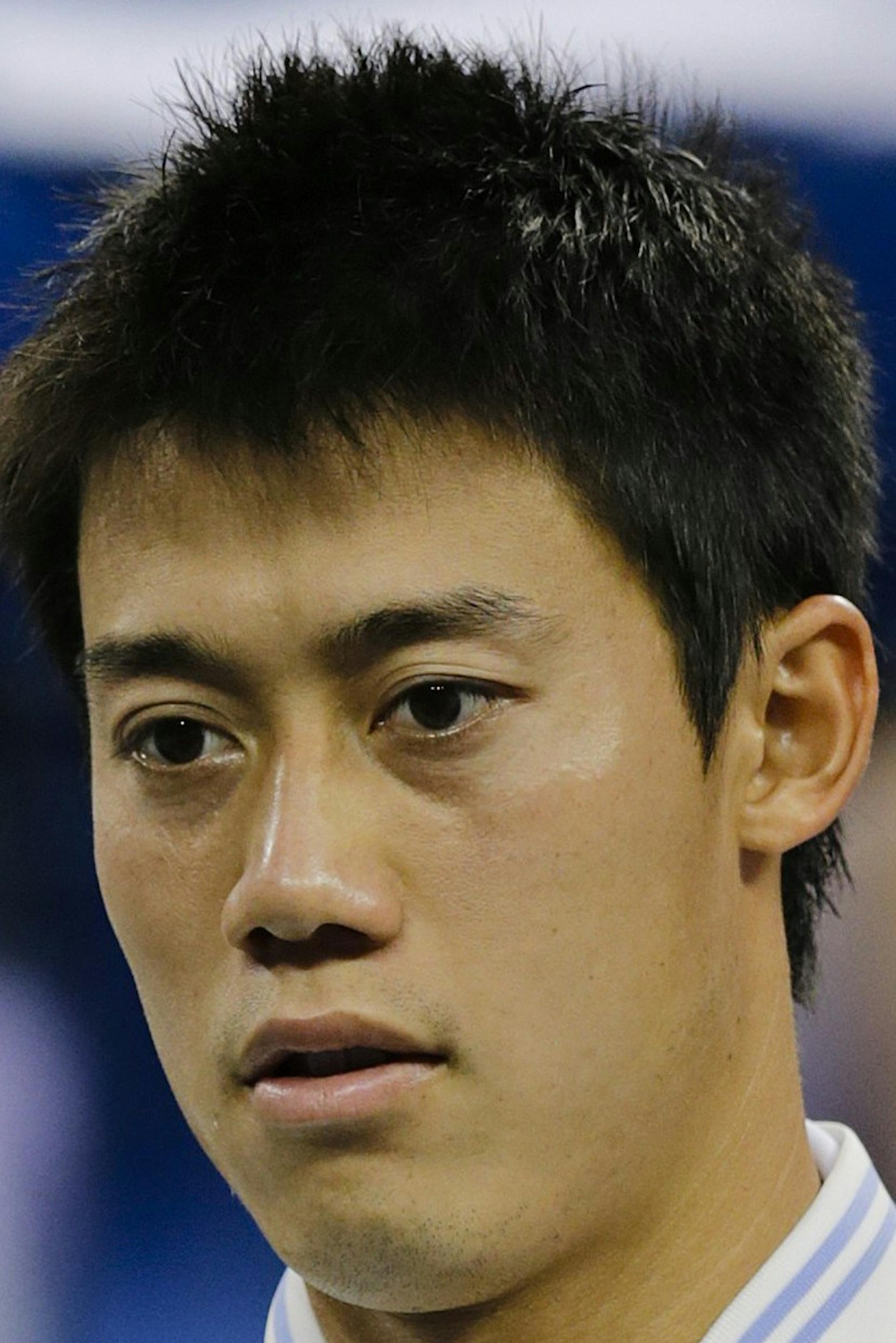 Kei Nishikori, of Japan, stands with the second place trophy after losing to Marin Cilic, of Croatia, in the championship match of the 2014 U.S. Open tennis tournament, Monday, Sept. 8, 2014, in New York. (AP Photo/Charles Krupa)