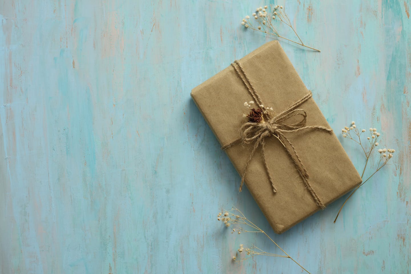 Gift box in recycled paper on wood background