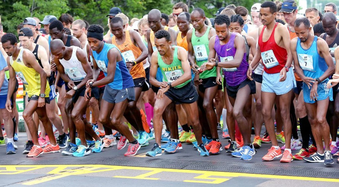 Elite runners set their watches as they took at the start of Grandma's Marathon in June 2017.