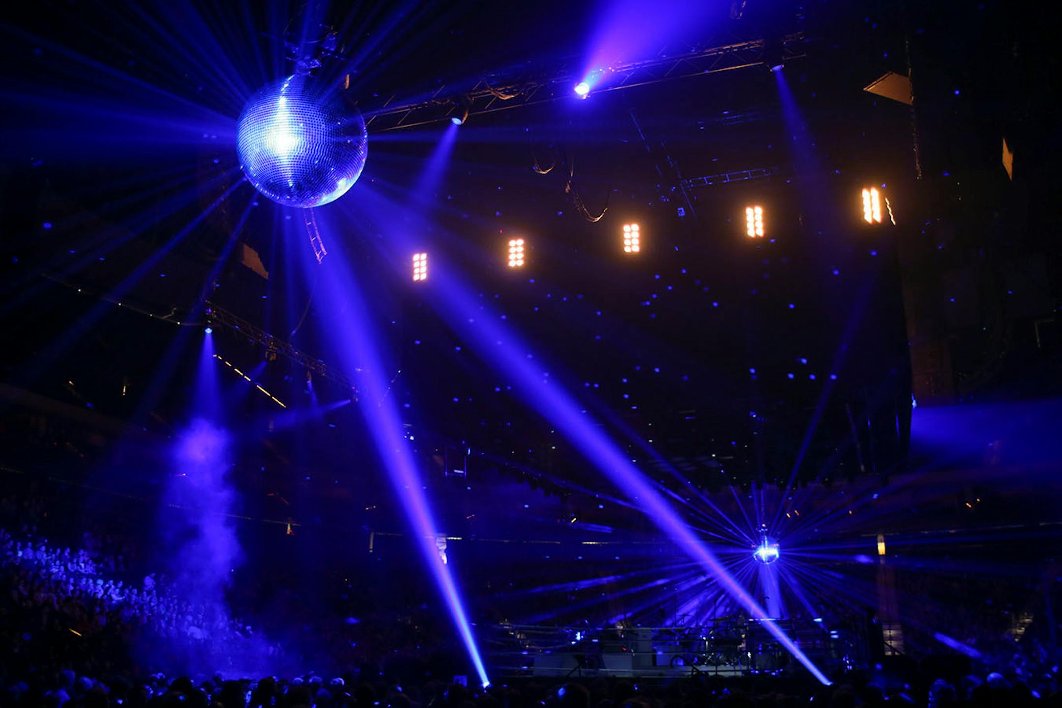 Disco balls overed over the audience before the Arcade Fire began their show Sunday night.