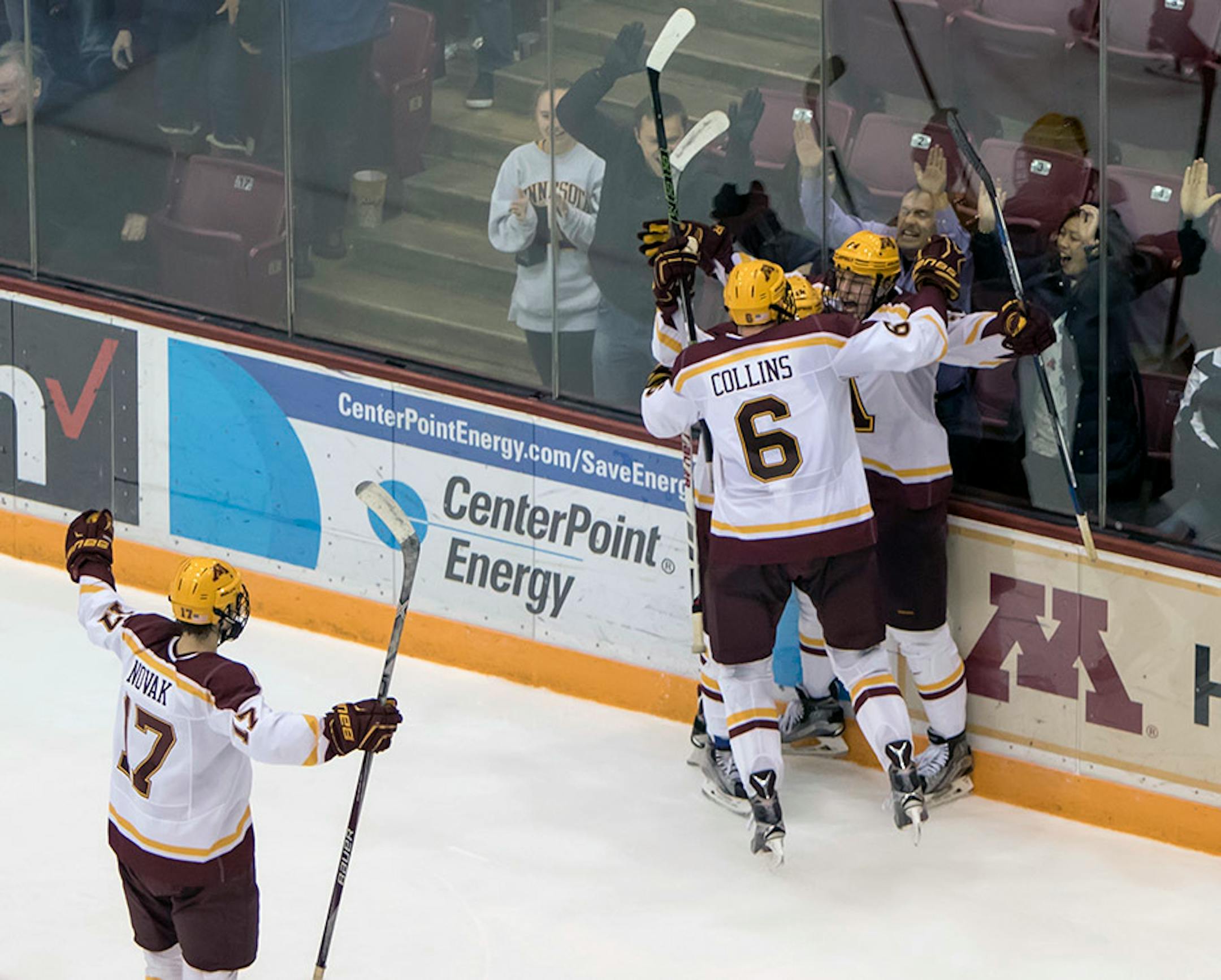 Minnesota Golden Gophers' forward Hudson Fasching (24), forward Leon Bristedt (18), Ryan Collins (6), forward Tommy Novak (17) celebrate Fasching's game winning overtime goal as the Minnesota Golden Gophers hosted the Ohio State Buckeyes to open the Big Ten Conference schedule on December 4, 2015. ] Special to Star Tribune MATT BLEWETT ï matt@mattebphoto.com - December 4, 2015, Minneapolis, MN, Big Ten Hockey, Minnesota Golden Gophers vs. Ohio State Buckeyes, 257622 UPUK 120415