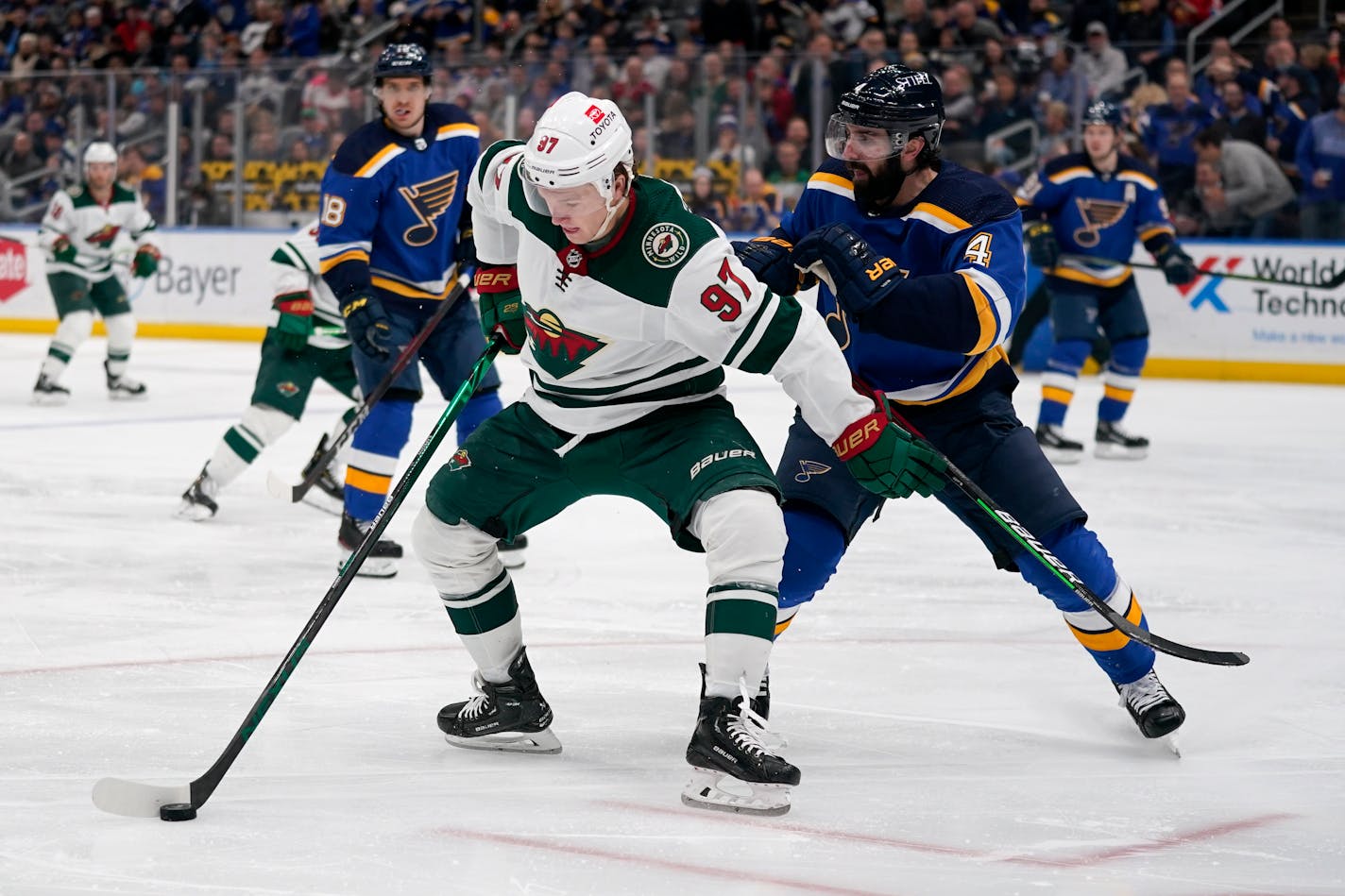 Minnesota Wild's Kirill Kaprizov (97) controls the puck as St. Louis Blues' Nick Leddy (4) defends during the third period of an NHL hockey game Friday, April 8, 2022, in St. Louis. (AP Photo/Jeff Roberson)