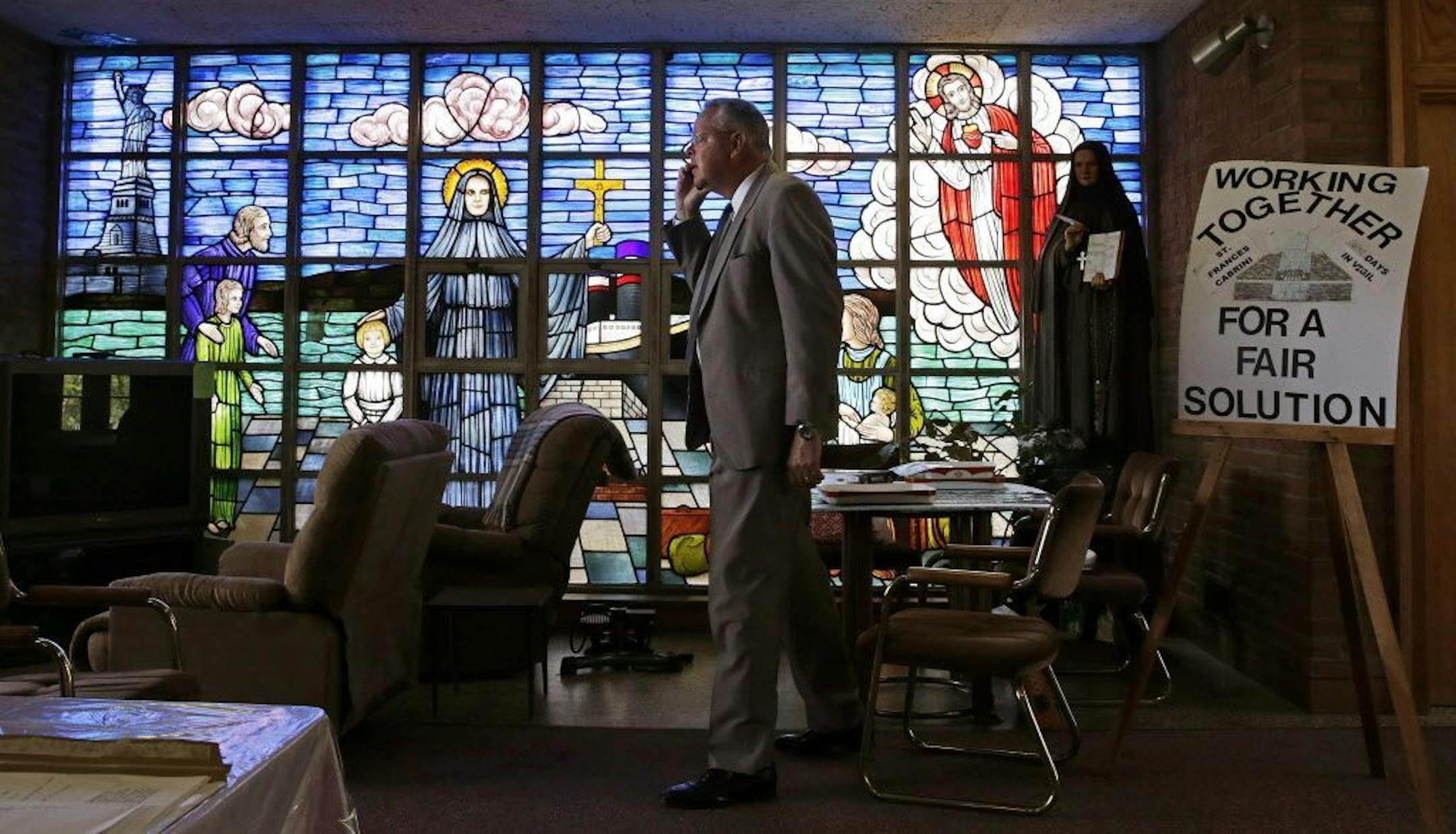 Jon Rogers, a lead organizer in an effort to save the church, talks on the telephone regarding an appeal against a state decision to vacate the building, while standing in the lobby at the St. Frances Xavier Cabrini Church in Scituate, Mass., Wednesday, May 20, 2015. Parishioners occupying a closed Catholic church for nearly 11 years may be at their end. A state judge has ordered the Friends of St. Frances X. Cabrini, which has occupied the church day and night since October 2004, to vacate by M