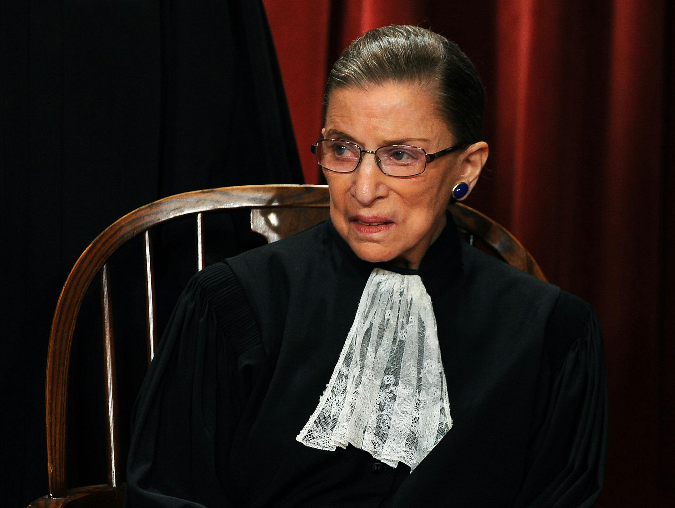 Ruth Bader Ginsberg sits with fellow Supreme Court Justices of the United States for a formal group photo in 2010. Bader Ginsburg broke three ribs in a fall Wednesday at her office and is recovering in the hospital. (Roger L. Wollenberg/Abaca Press/TNS)