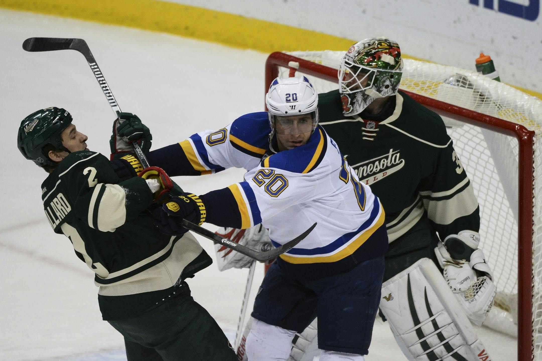 Minnesota Wild defenseman Keith Ballard (2) and St. Louis Blues left wing Alexander Steen (20) get into a tussle in front of the Minnesota's goal in the first period.