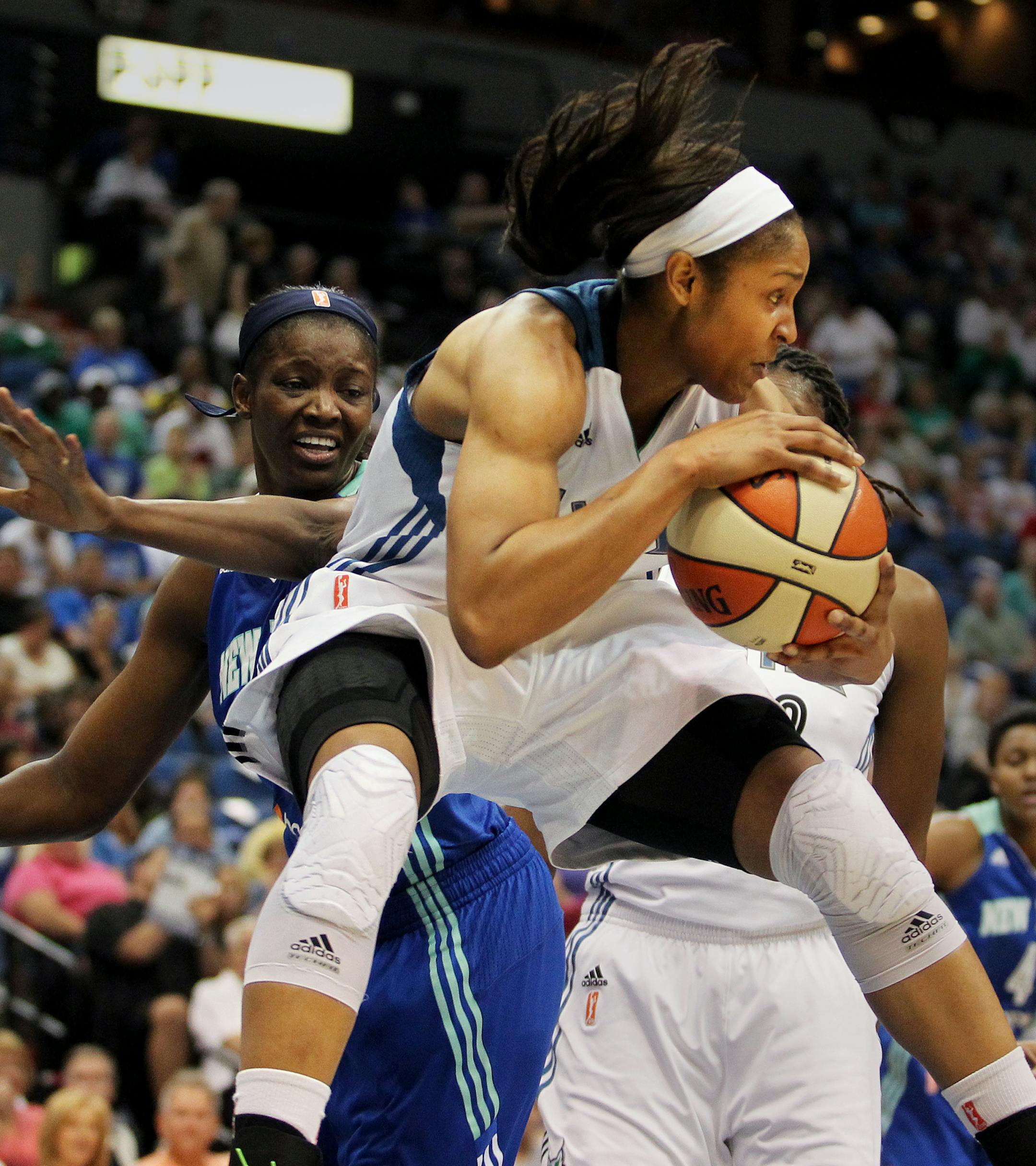 Minnesota's Maya Moore (23) leaps and protects her rebounded ball from New York's DeLisha Milton-Jones (1) in the first half of the New York Liberty vs. Minnesota Lynx basketball game at the Target Center in Minneapolis, Minn., on Sunday, August 18, 2013. The Lynx lead 43-34 at the half. ] (ANNA REED/STAR TRIBUNE) anna.reed@startribune.com (cq) ORG XMIT: MIN1308181917064015 ORG XMIT: MIN1308182025054078