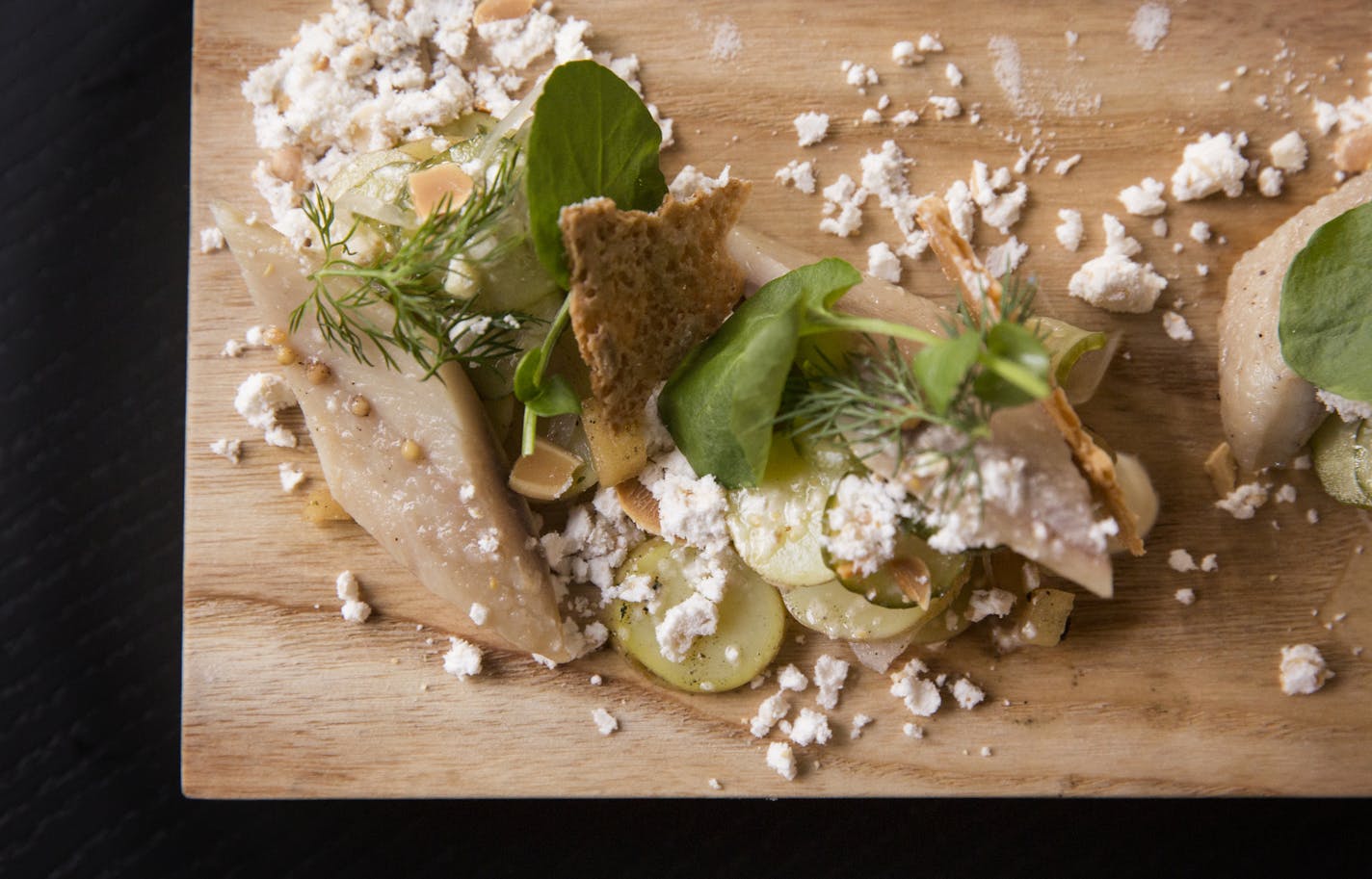 Pickled herring with apples, cucumber and dill.